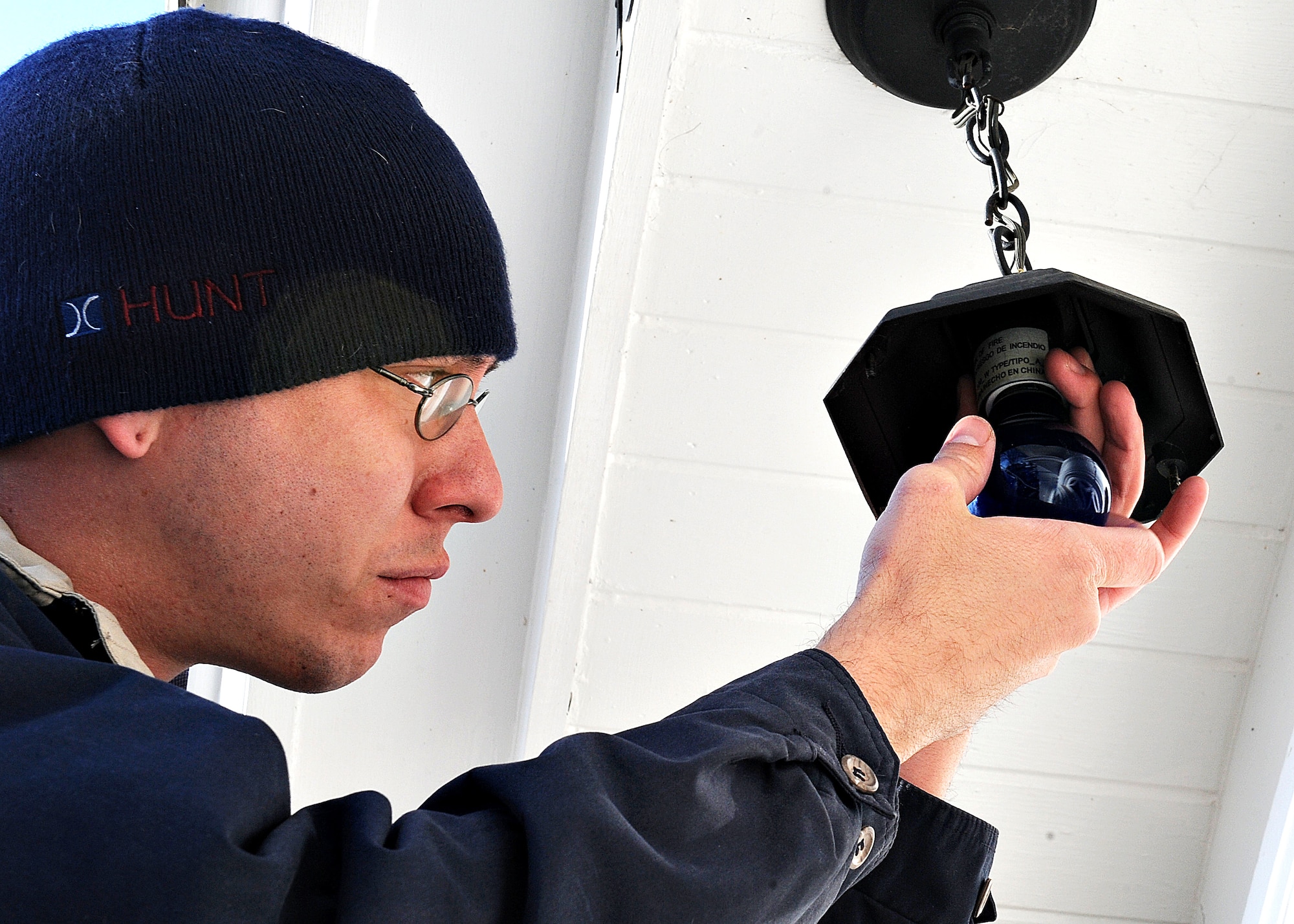 Don Huschle, Scott Family Housing porter, installs blue lights in Colonial Housing at Scott Air Force Base, Ill., Mar. 27, 2013. Light It Up Blue is a worldwide project, in which buildings and homes display blue lights to spread autism awareness. (U.S. Air Force photo/A1C Jaeda Waffer)
