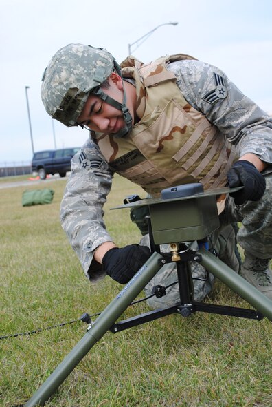 Senior Airman Richard Brcka from the 319th Operations Support Squadron Weather Flight begins setting up weather monitoring equipment during a readiness exercise, March 1, 2013, at Grand Forks Air Force Base, N.D. In the field and focused on operational weather; the Weather Flights are the third tier of Air Force Weather and the prime interface with an installation's flying and ground operations. (U.S Air Force photo/Staff. Sgt. Luis Loza Gutierrez)