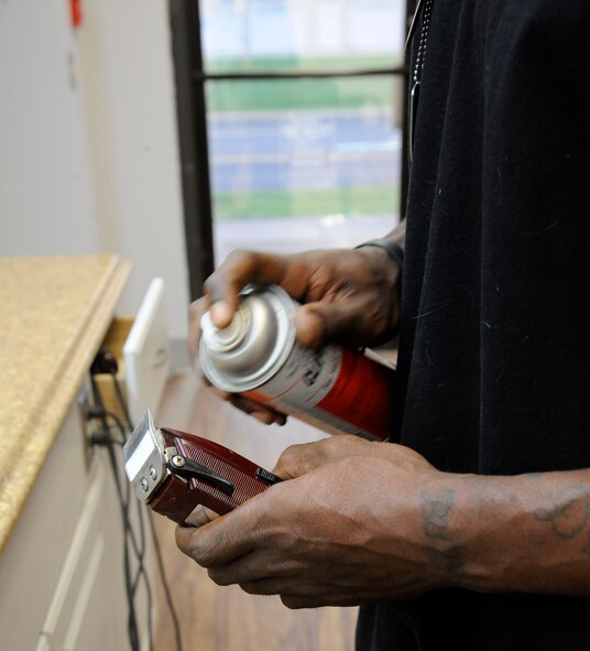Haynes Delvin cleans a hair buzzer at the Stripes Club barber shop on Barksdale Air Force Base, La., April 3, 2013. The barber shop opened April 1 to replace the barber shop on Barksdale Boulevard which is soon closing. The Stripes Club's barber shop's hours of operation are from 8 a.m. to 4 p.m. Monday through Friday. (U.S. Air Force photo/Airman 1st Class Andrew Moua)