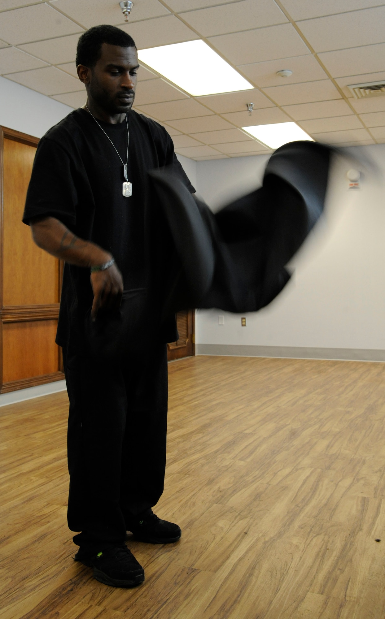 Haynes Delvin shakes the hair out of an apron at the Stripes Club barber shop on Barksdale Air Force Base, La., April 3, 2013. The barber shop opened April 1 to replace the barber shop on Barksdale Boulevard which is soon closing. The Stripes Club's barber shop's hours of operation are from 8 a.m. to 4 p.m. Monday through Friday. (U.S. Air Force photo/Airman 1st Class Andrew Moua)