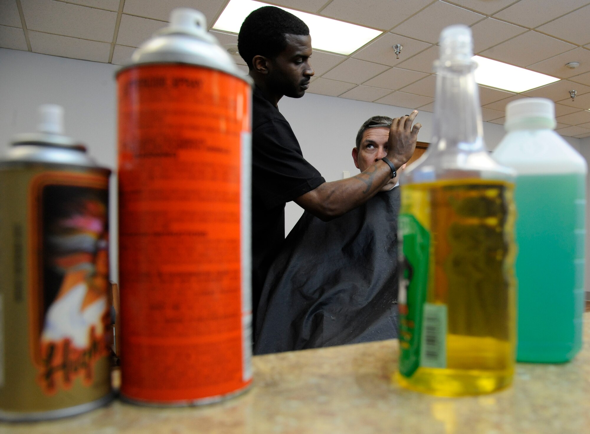 Haynes Delvin trims the hair of a customer at the Stripes Club barber shop on Barksdale Air Force Base, La., April 3, 2013. The barber shop opened April 1 to replace the barber shop on Barksdale Boulevard which is soon closing. The Stripes Club's barber shop's hours of operation are from 8 a.m. to 4 p.m. Monday through Friday. (U.S. Air Force photo/Airman 1st Class Andrew Moua)