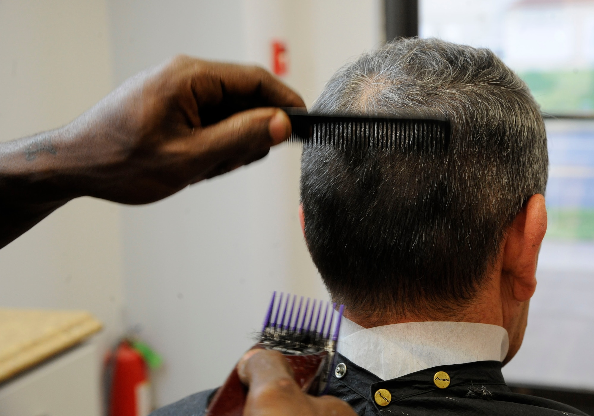Haynes Delvin cuts the hair of a customer at the Stripes Club barber shop on Barksdale Air Force Base, La., April 3, 2013. The barber shop opened April 1 to more easily cater to Team Barksdale's needs of dress and appearance. The Stripes Club's barber shop's hours of operation are from 8 a.m. to 4 p.m. Monday through Friday. (U.S. Air Force photo/Airman 1st Class Andrew Moua)