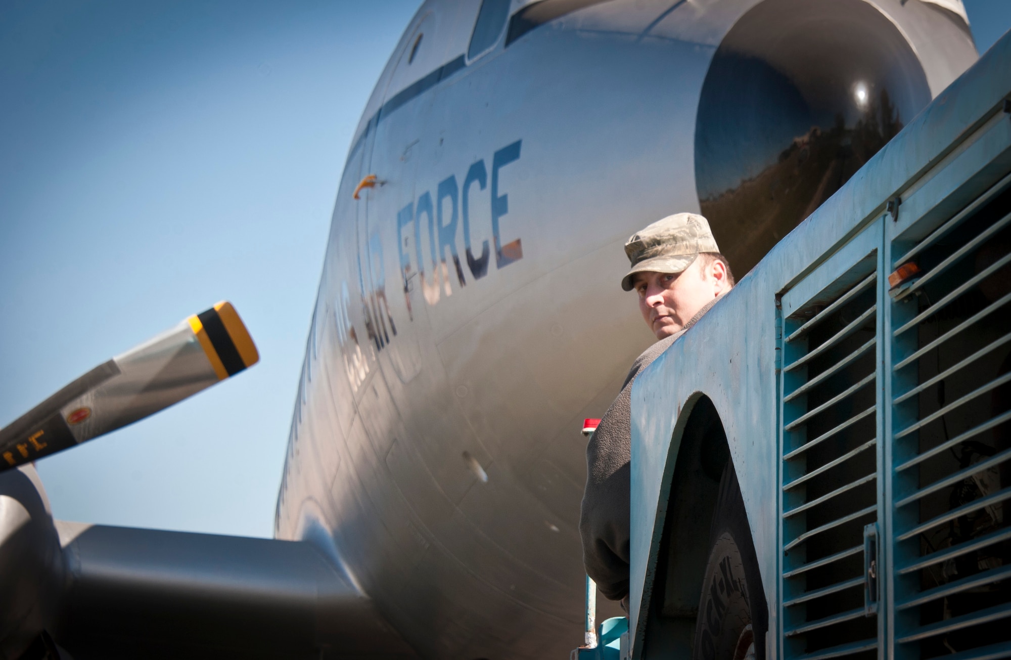 Tech. Sgt. David Whealton, 514th Maintenance Squadron crew chief, checks behind the tow truck to ensure not to hit any obstructions while towing a C-118 Liftmaster down West Arnold Avenue to its static display location in front of the McGuire Passenger Terminal on Joint Base McGuire-Dix-Lakehurst, N.J., March 30, 2013. Whealton was a contributing member of the restoration team who has worked to refurbish the C-118 since October 2009. Whealton is a Chincoteague, Va., native. (U.S. Air Force photo by Staff Sgt. David Carbajal/Released)