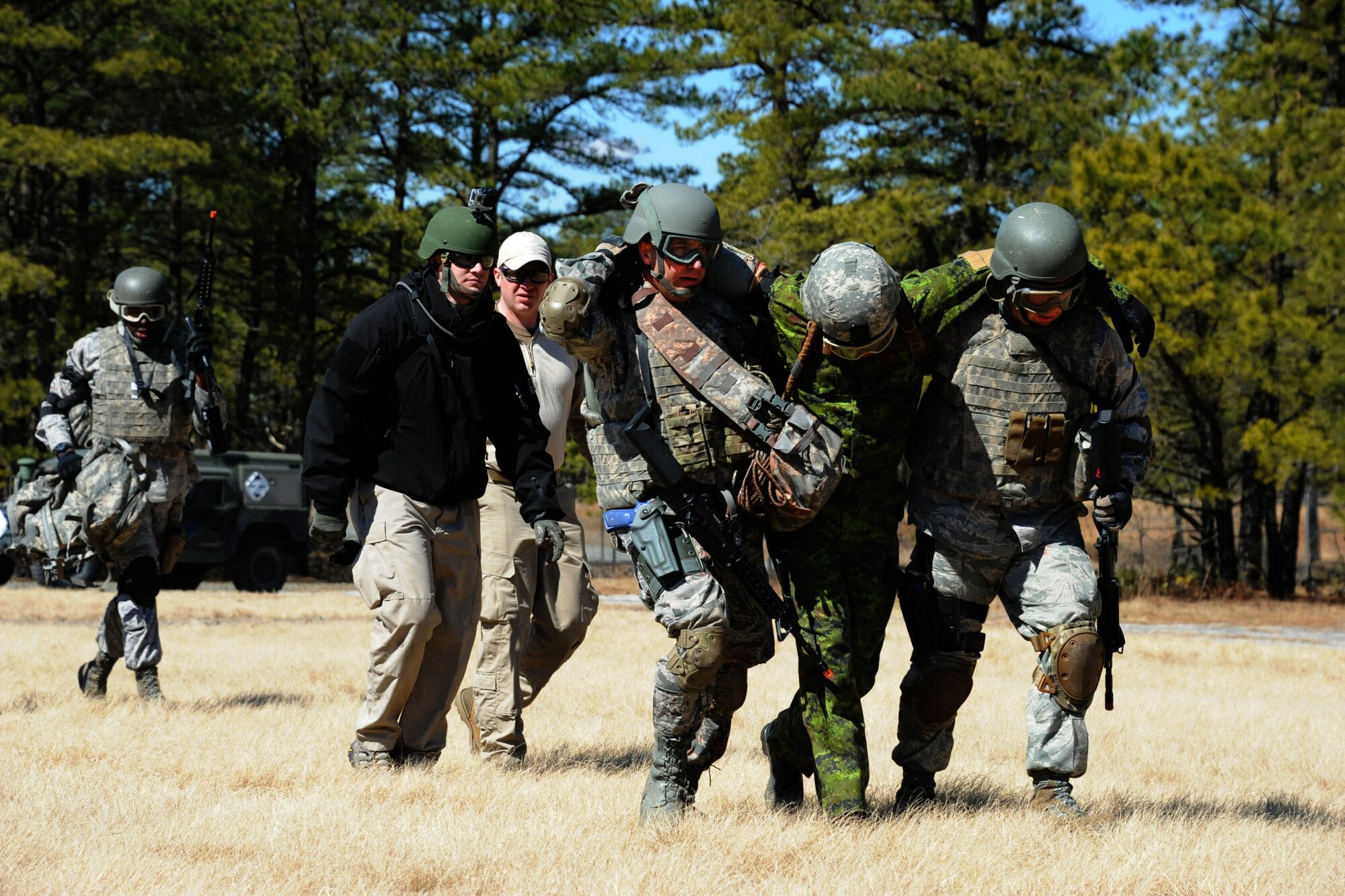 U.S. Air Force Air Advisor Academy students evacuate a simulated injured service member, to a CH-53E Super Stallion at Joint Base McGuire-Dix-Lakehurst, N.J., March 29, 2013. Academy students learn the skills necessary to operate in any environment and culture. Students learn languages, combat skills, tactics and procedures during their training. (U.S. Air Force photo by Airman Sean M. Crowe/Released)