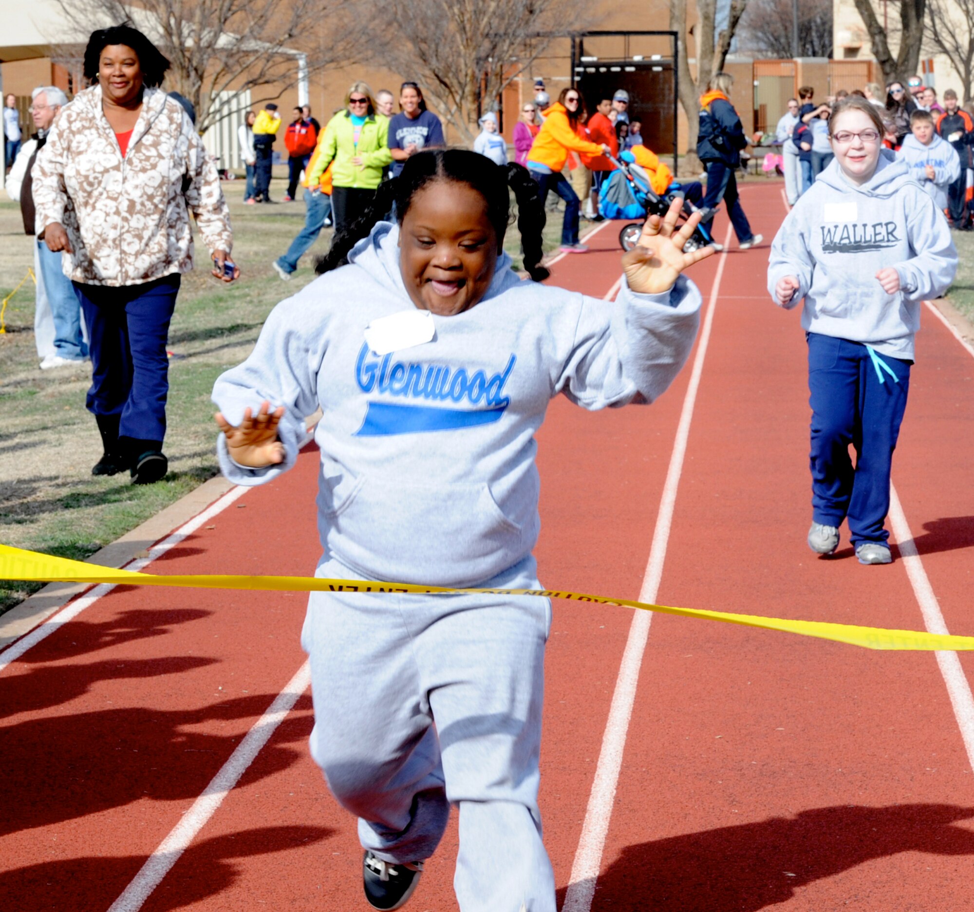 A special Olympian crosses the 50-meter dash finish line during the 44th Cherokee Strip Area 6 Special Olympics held March 28 at Vance Air Force Base, Okla. (U.S. Air Force photo/ Senior Airman Frank Casciotta)