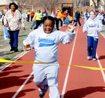 A special Olympian crosses the 50-meter dash finish line during the 44th Cherokee Strip Area 6 Special Olympics held March 28 at Vance Air Force Base, Okla. (U.S. Air Force photo/ Senior Airman Frank Casciotta)