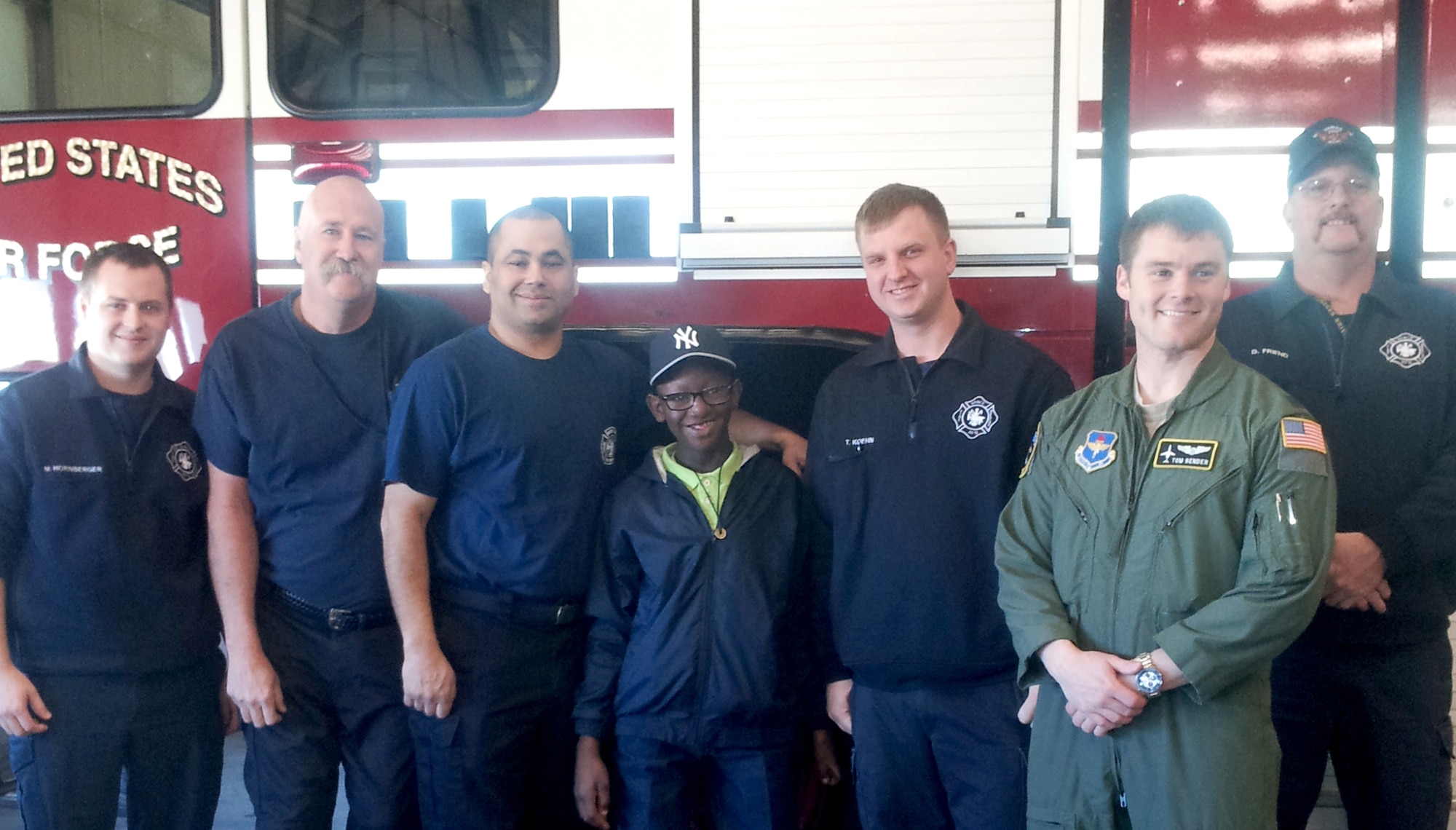 Saliman Bachilly-Redd, center, visits the Vance Fire Department during his special tour of Vance Air Force Base, Okla., March 26. His guide, Capt. Tom Bender, in flight suit, spent the day showing him the outstanding work of Airmen in all parts of the flying operation. The firemen are, from left, Mason Hornberger, Phil Luginbill, Aaron Creason, Tyler Koehn and David Friend. (Courtesy photo) 