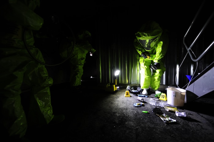 Michelle Bates, 628th Civil Engineer Squadron Emergency Management manager, checks her readings on a MultiRae, used to detect oxygen levels in the air, while scanning for simulated chemical contaminants during an exercise March 28, 2013, at Joint Base Charleston-Air Base, S.C. The response team was tasked to enter an area and collect and identify possible hazardous substances. The exercise gave the Emergency Management and Bioenvironmental Flights an opportunity to train for possible real world situations that may involve all hazards that may present a physical threat to the environment at Air Force installations worldwide. (U.S. Air Force photo by Staff Sgt. Rasheen Douglas)