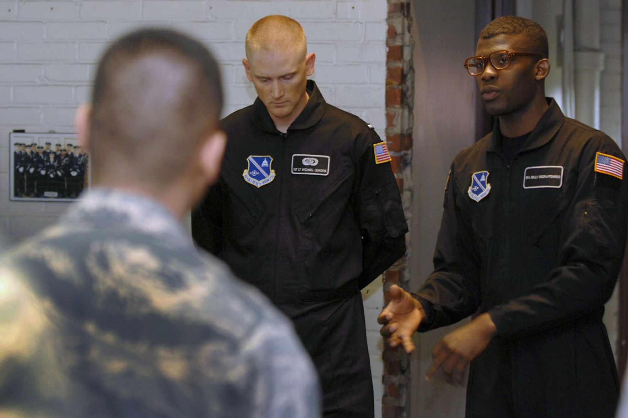 Senior Airman Billy Degraffenreid, a member of the U.S. Air Force Honor Guard Drill Team (right), gives instructions to members of the honor guard at Langley Air Force Base. Va., March 29, 2013. The drill team came to coach Langley’s honor guard members, as well as to perform a demonstration at the Air Combat Command Fitness Center to recruit Airmen for the drill team. (U.S. Air Force photo by Staff Sgt. Jeff Nevison/Released)