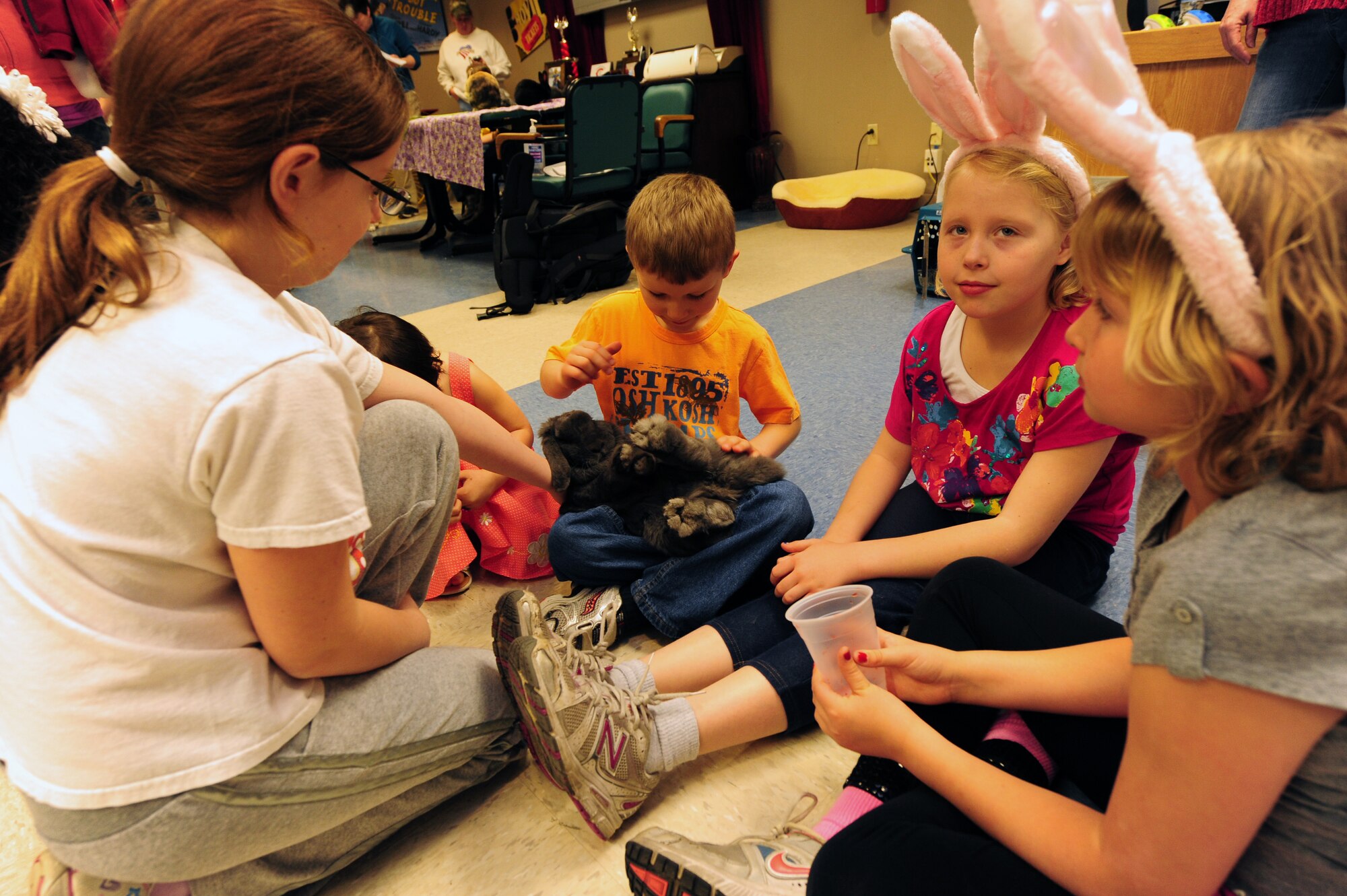 Children take turns petting a rabbit at the Missouri Veterans Home’s second annual Easter Egg Hunt and family celebration in Warrensburg, Mo., March 30, 2013. The event was organized to boost morale among veterans and families and was supported by more than 70 volunteers from Whiteman Air Force Base. (U.S. Air Force photo by Staff Sgt. Nick Wilson/Released)