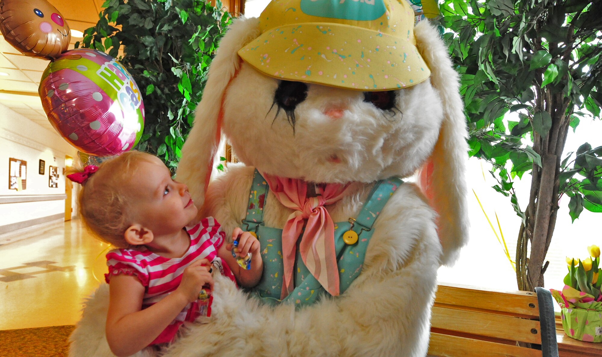A child plays with the Easter bunny at the Missouri Veterans Home’s second annual Easter Egg Hunt and family celebration in Warrensburg, Mo., March 30, 2013. More than 70 volunteers from Whiteman Air Force Base contributed to the success of the event. (U.S. Air Force photo by Staff Sgt. Nick Wilson/Released)