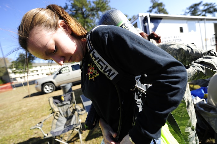 Michelle Bates, 628th Civil Engineer Squadron Emergency Management manager, dons a Level A HAZMAT suit during an exercise March 28, 2013, at Joint Base Charleston - Air Base, S.C. Bates was a member of the second response team during the exercise and was responsible for collecting and identifying possible hazardous substances. The exercise gave the Emergency Management and Bioenvironmental Flights the opportunity to train for possible real-world situations involving all hazards that may present a physical threat to the environment at Air Force installations worldwide. (U.S. Air Force photo by Staff Sgt. Rasheen Douglas)