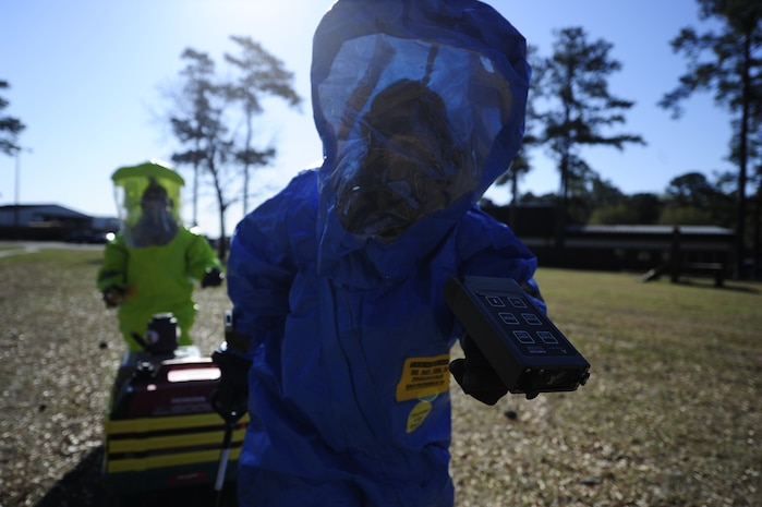 Senior Airman Nicole Browning, 628th Civil Engineer Squadron emergency management journeyman, simulates using an ADM-300 to detect alpha, beta and gamma radiation during an exercise March 28, 2013, at Joint Base Charleston - Air Base, S.C. The 628th MDG Bioenvironmental Flight trains with the 628th CE Emergency Management Flight to refine their emergency response skills and to improve their preparedness and response initiatives. (U.S. Air Force photo by Staff Sgt. Rasheen Douglas)