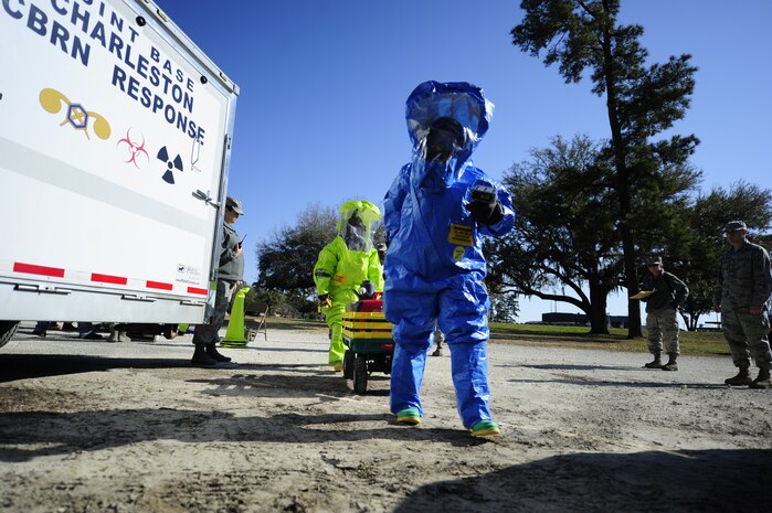 Senior Airman Nicole Browning, 628th Civil Engineer Squadron emergency management journeyman (blue suit), and Staff Sgt. Jessica McFelia, 628th Medical Group bioenvironmental engineer craftsman (green suit), prepare to clear an area during an exercise March 28, 2013, at Joint Base Charleston - Air Base, S.C. The 628th MDG Bioenvironmental Flight trains with the 628th CE Emergency Management Flight to refine their emergency response skills and to improve their preparedness and response initiatives. (U.S. Air Force photo by Staff Sgt. Rasheen Douglas)