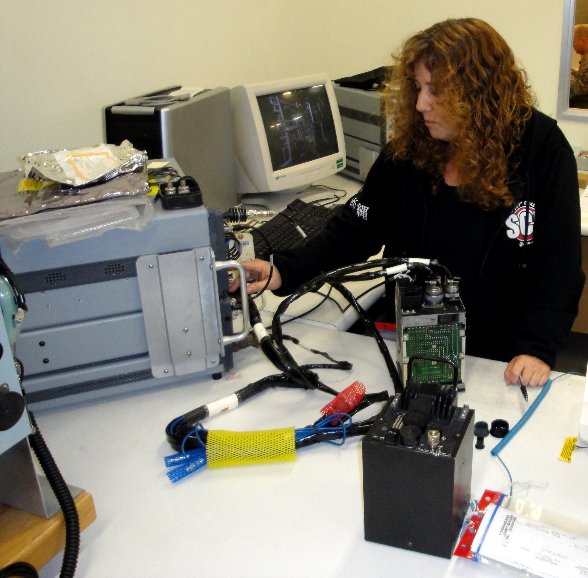 Leslie Hutchison, Electronics Integrated Systems Mechanic, performs avionics repair at Kadena Air Base, Japan. Hutchison is assigned to the 525th Electronics Maintenance Squadron, a geographically separated unit of the Ogden Air Logistics Complex. (Air Force photo)