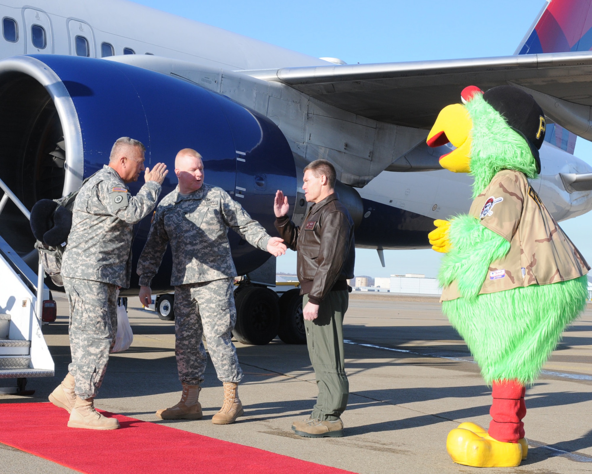 Col. Craig C. Peters, commander of the 911th Airlift Wing, joins Col. Bryan Peterson, Chief of Staff for the 316th Expeditionary Sustainment Command, and the Pittsburgh Pirate Parrot as they welcome home Brig. Gen. Bud R. Jameson Jr., Commanding General for the 316th ESC, and 120 other unit members returning after a year away from home, March 30, 2013. Members of the 316th ESC were deployed to Kuwait in support of Enduring Freedom providing food, fuel, ammunition, water, transportation, maintenance and soldier services in the Middle East. (U.S. Army photo by Sgt. 1st Class Brian Scott/Released)