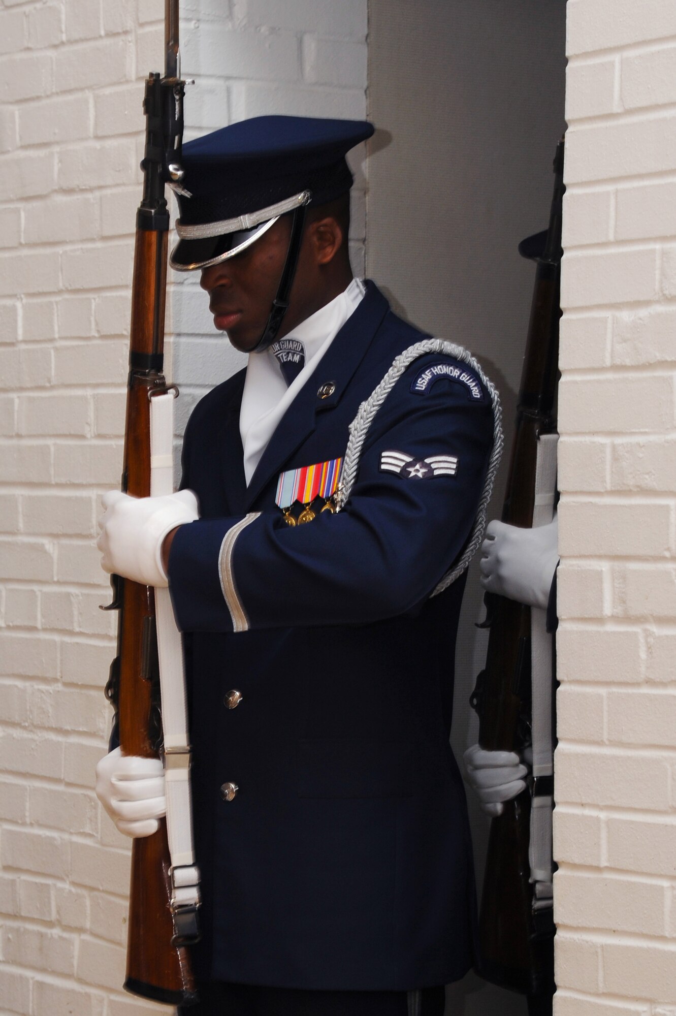 U.S. Air Force Senior Airman Jimmy Pryor, U.S. Air Force Honor Guard Drill Team member performs during a recruitment visit at Langley Air Force Base, Va., March 29, 2013. The Honor Guard Drill Team performance featured professionally choreographed sequence maneuvers, tosses and complex weapon exchanges. (U.S. Air Force photo by Airman 1st Class Victoria H. Taylor/Released)