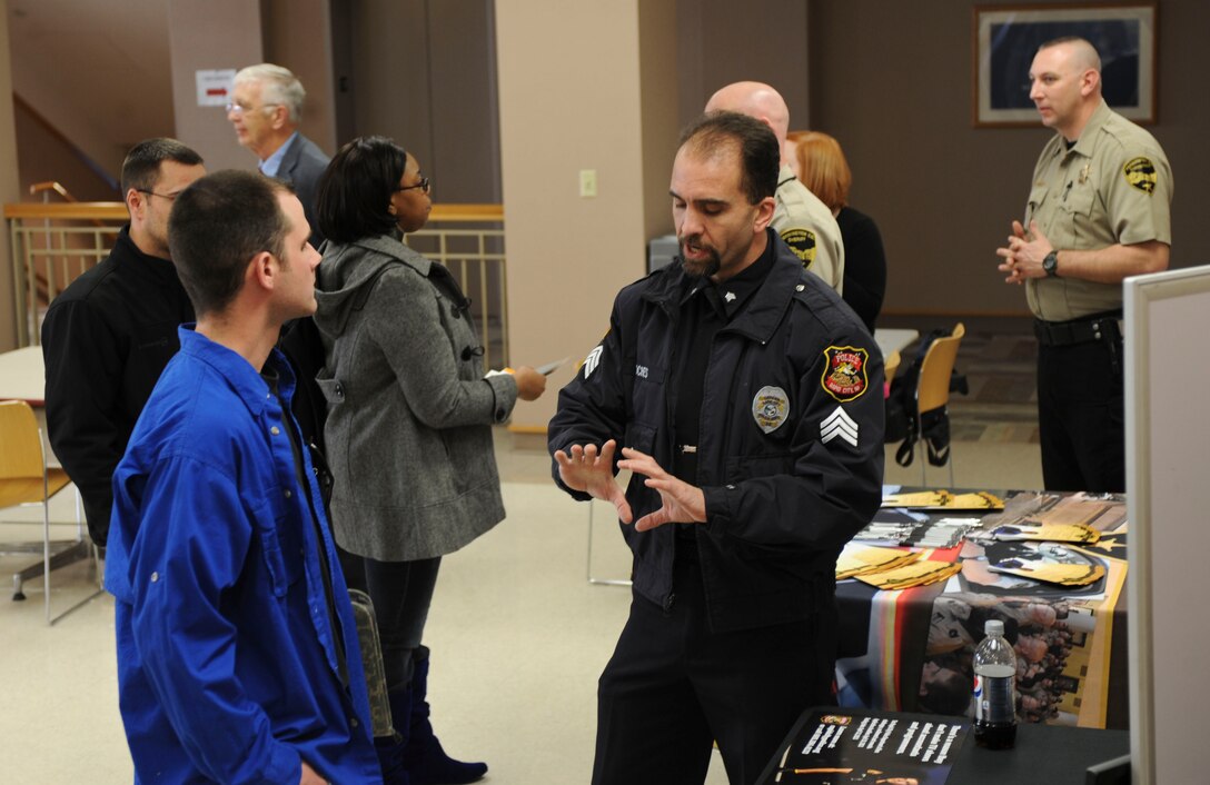 Representatives from different organizations in the area discuss employment opportunities during a “Meet The Employer” workshop at the Rushmore Center on Ellsworth Air Force Base, S.D., March 26, 2013. The workshop helps retiring or separating service members and their families find future employment opportunities throughout the region. (U.S. Air Force photo by Airman 1st Class Anania Tekurio/Released)