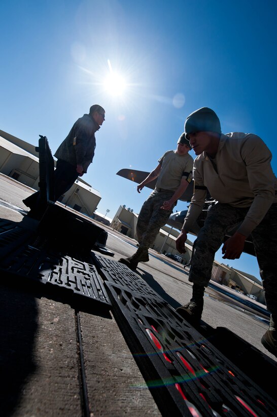 Senior Airman Kerry Bowden (left), Senior Airman Terri Morris, and Airman 1st Class Stefon Douglas, 28th Aircraft Maintenance Squadron aerospace propulsion technicians, arrange tools used to inspect a B-1 bomber’s propulsion system at Ellsworth Air Force Base, S.D., March 28, 2013.  Aerospace propulsion technicians are responsible for maintaining and diagnosing engine issues including fuel, oil, electrical and airflow malfunctions. (U.S. Air Force photo by Airman 1st Class Zachary Hada/Released)