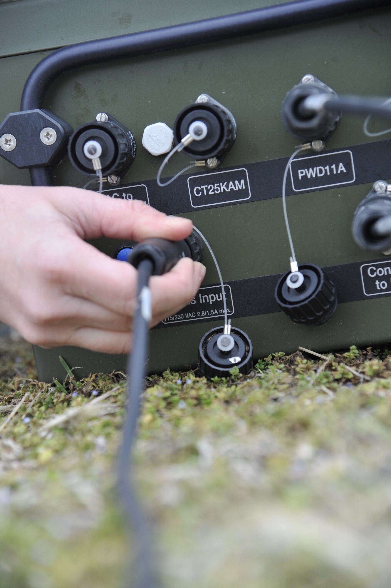 U.S. Air Force Senior Airman Heather Rieck, 509th Operation Support Squadron weather journeyman, plugs a cord into the TMQ-53’s power source, Whiteman Air Force Base, Mo., March 20, 2013. The power source supplies power to all equipment on the TMQ-53 to give it accurate readings. (U.S. Air Force photo by Airman 1st Class Keenan Berry/Released)
