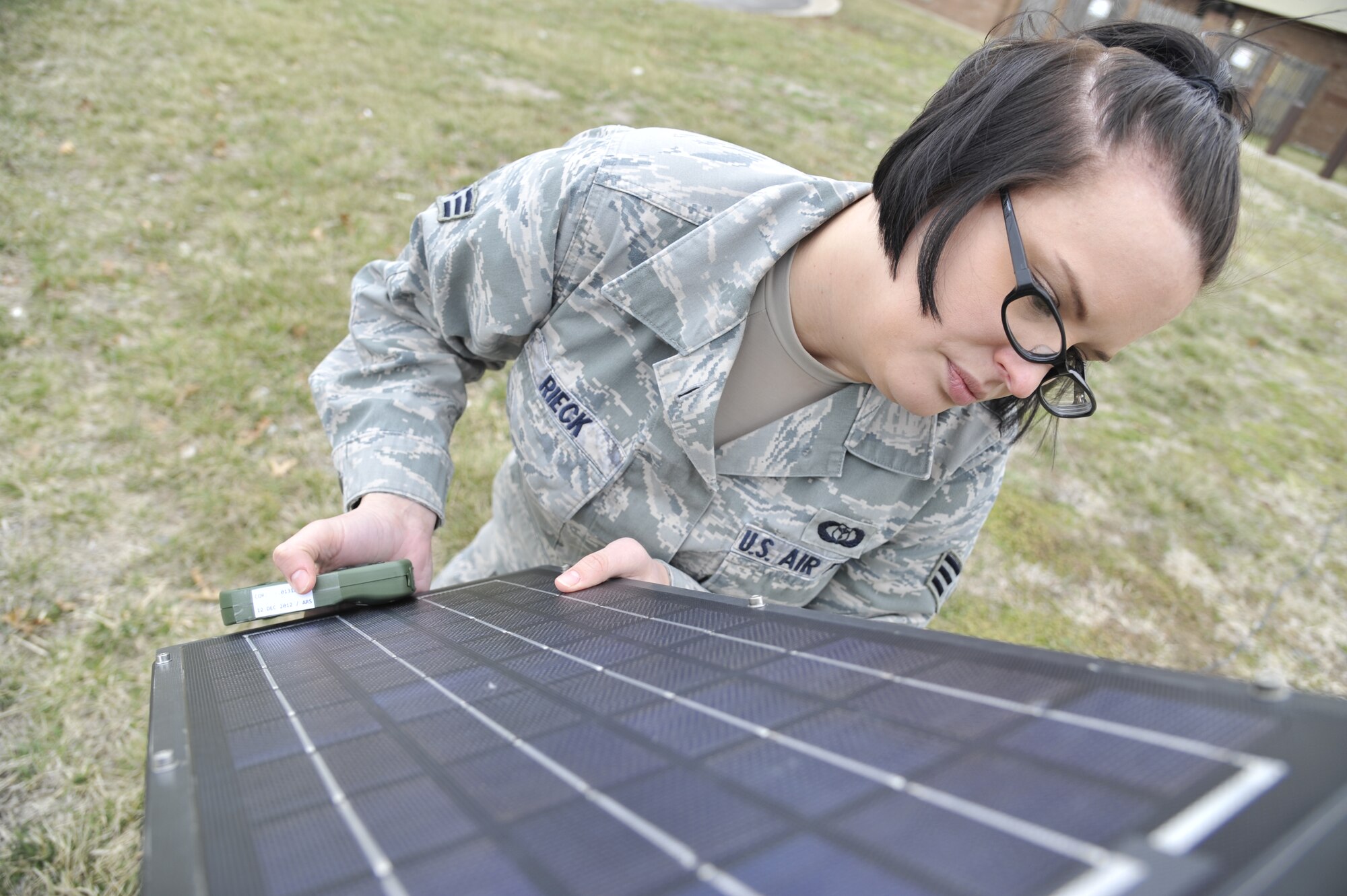 U.S. Air Force Senior Airman Heather Rieck, 509th Operation Support Squadron weather journeyman, adjusts a solar panel on a TMQ-53, Whiteman Air Force Base, Mo., March 20, 2013. The solar panel is aimed toward the sun to draw the most energy, providing power to equipment on the censor. (U.S. Air Force photo by Airman 1st Class Keenan Berry/Released)  
