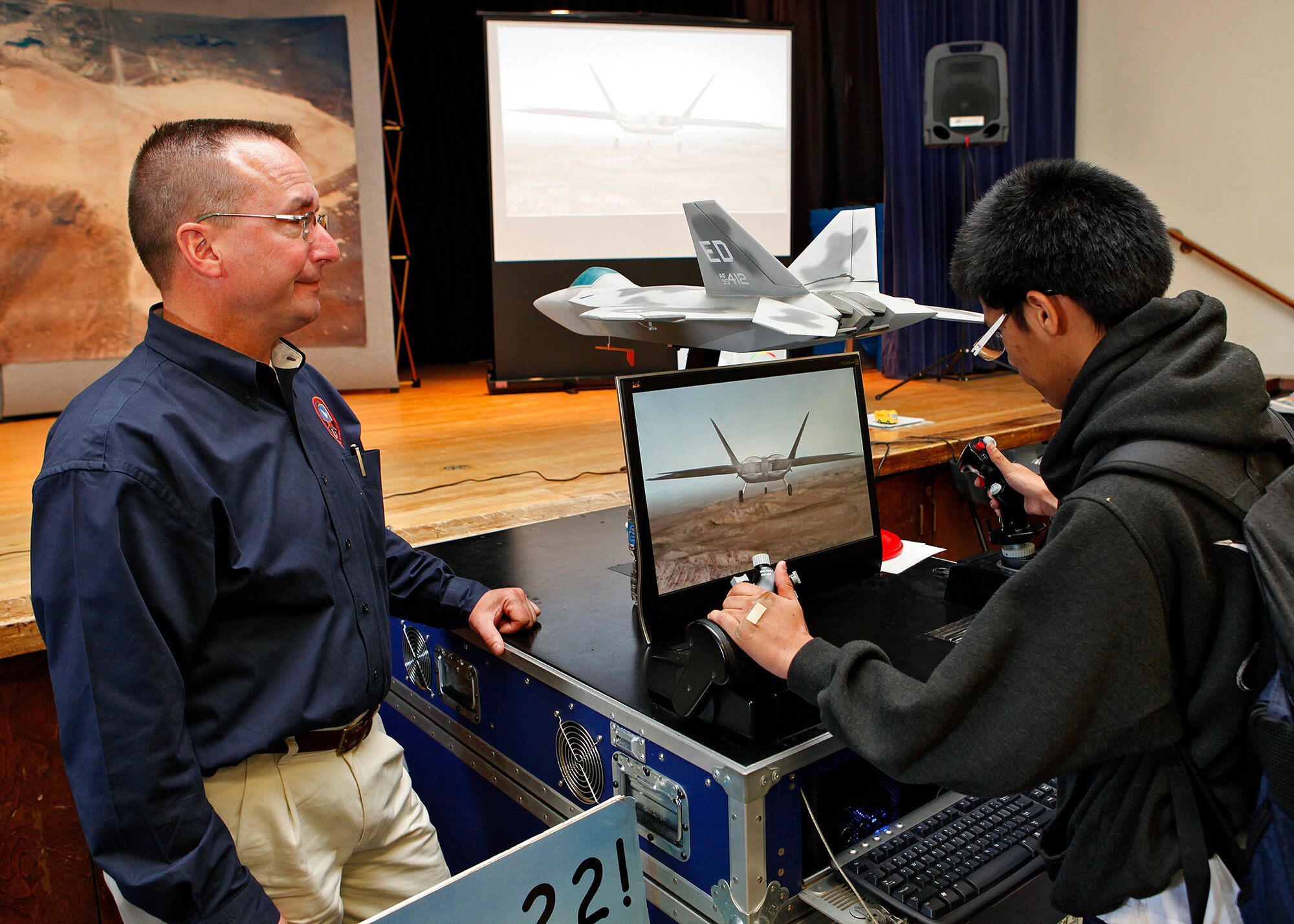 Jack Earl, 412th Test Wing instrumentation design engineer with the 412th Test Engineering Group, was just one of the many organizations that provided an information booth who attended the 2013 Career Fair at Desert High School March 29, 2013. The 412th TENG provided an interactive F-22 simulator display that students could fly as part of the day's activities. (U.S. Air Force photo by Jet Fabara)