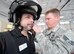 Senior Airman John Nelson, 436th Civil Engineer Squadron, adjusts the blast protective helmet worn by Mr. John Yoho, 436th Operations Support Squadron honorary commander, during a tour March 28, 2013, Dover Air Force Base, Del. Yoho volunteered to don the entire blast protective 'bomb suit' to gain an understanding of the conditions Explosive Ordnance Disposal personnel face when working. (U.S. Air Force photo/Greg L. Davis)
