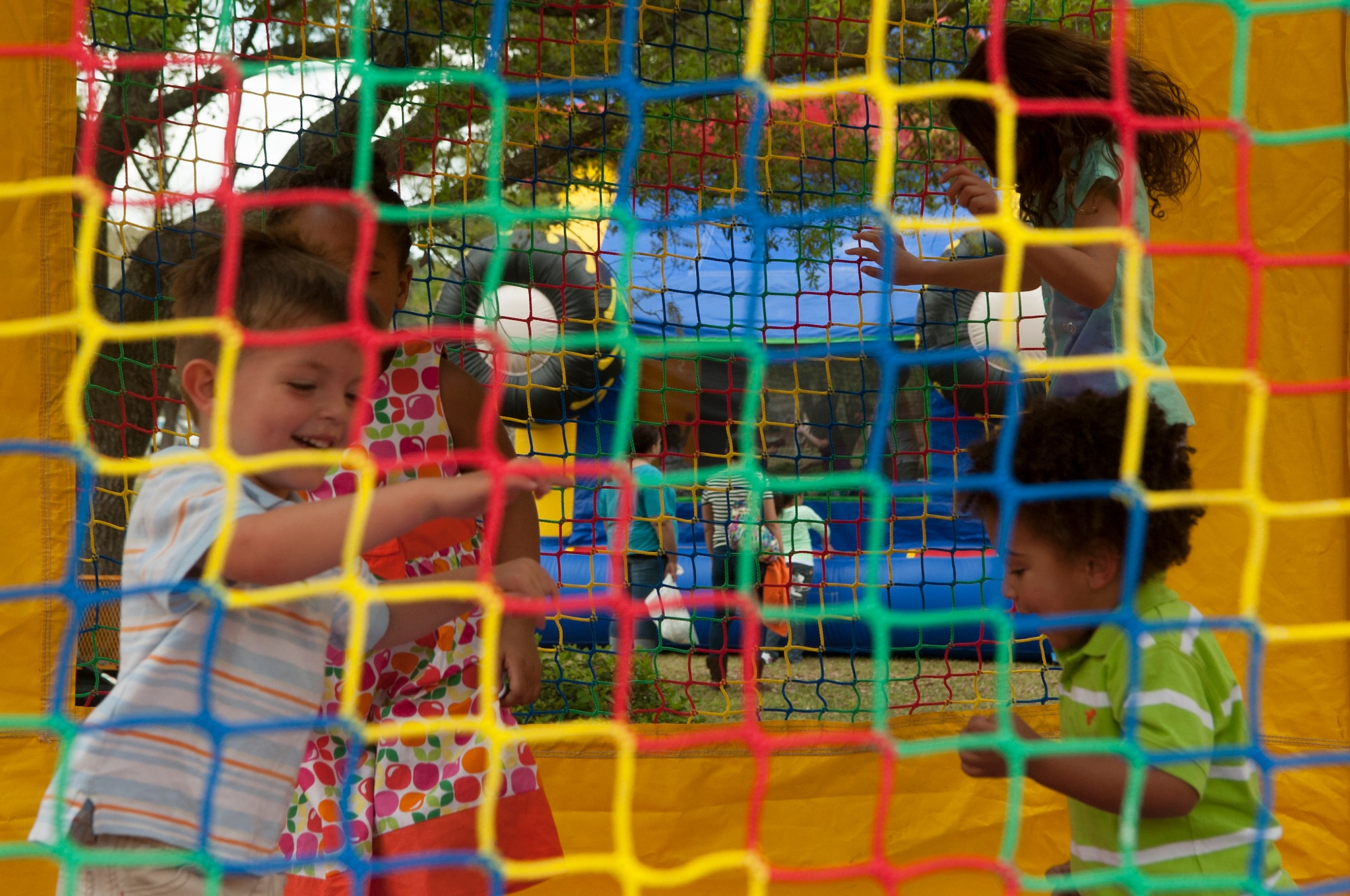 A group of children play inside a bounce house during the Annual Easter Egg Hunt March 31, 2013, at Moody Air Force Base, Ga.  Brunch, games and photos with the Easter Bunny were among other activities available for families during the event. (U.S. Air Force photo/Airman Paul Francis Released)
