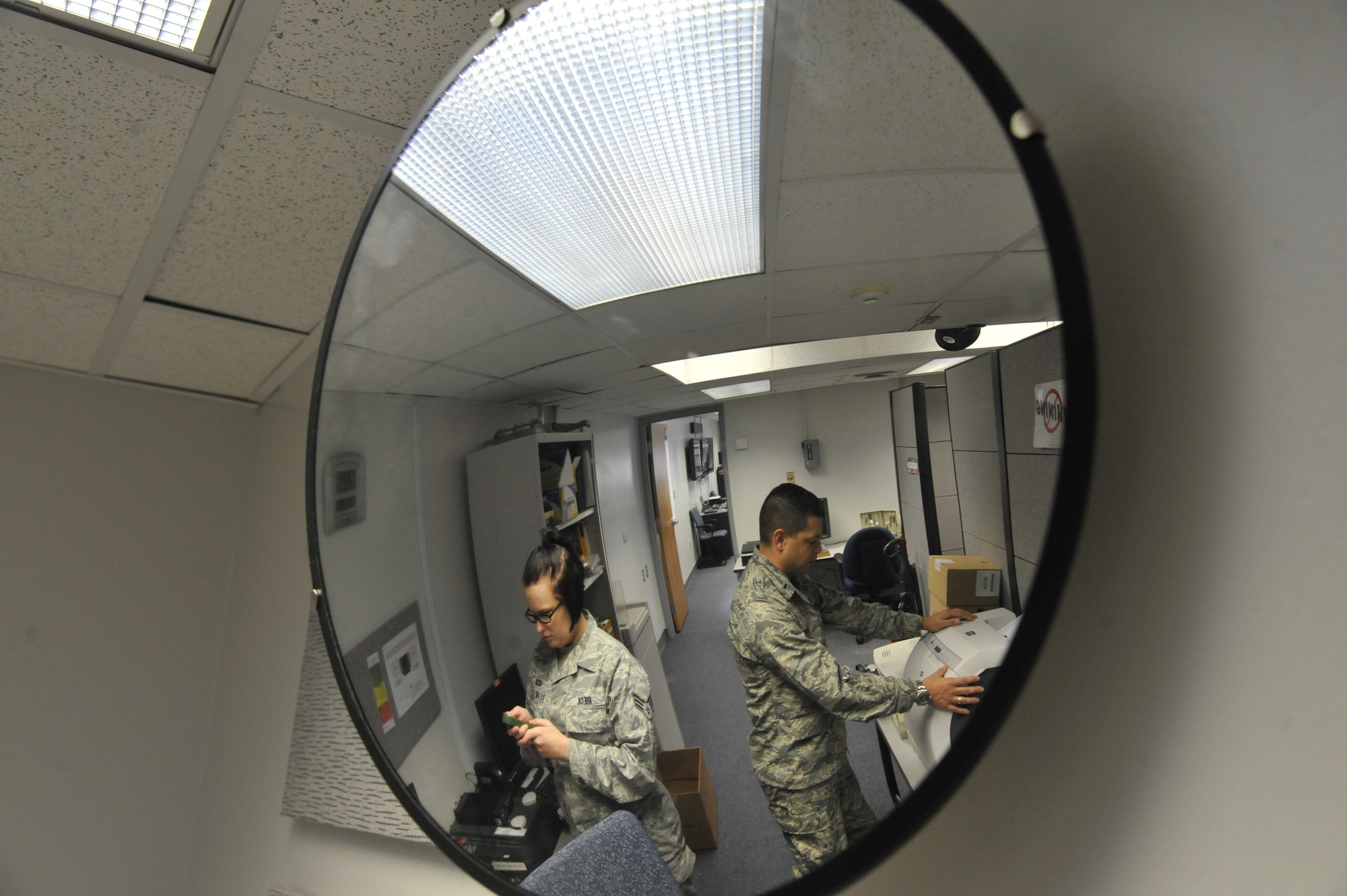 U.S Air Force 1st Lt. Jose Melendez, 509th Operation Support Squadron wing weather officer, (right) and U.S. Air Force Senior Airman Heather Rieck, 509th Operation Support Squadron weather journeyman, work in the weather office, Whiteman Air Force Base, Mo., March 20, 2013. Weather personnel have to observe the weather at all times in case it changes  in a way that may  impact the 
Whiteman mission. (U.S. Air Force photo by Airman 1st Class Keenan Berry/Released)   

