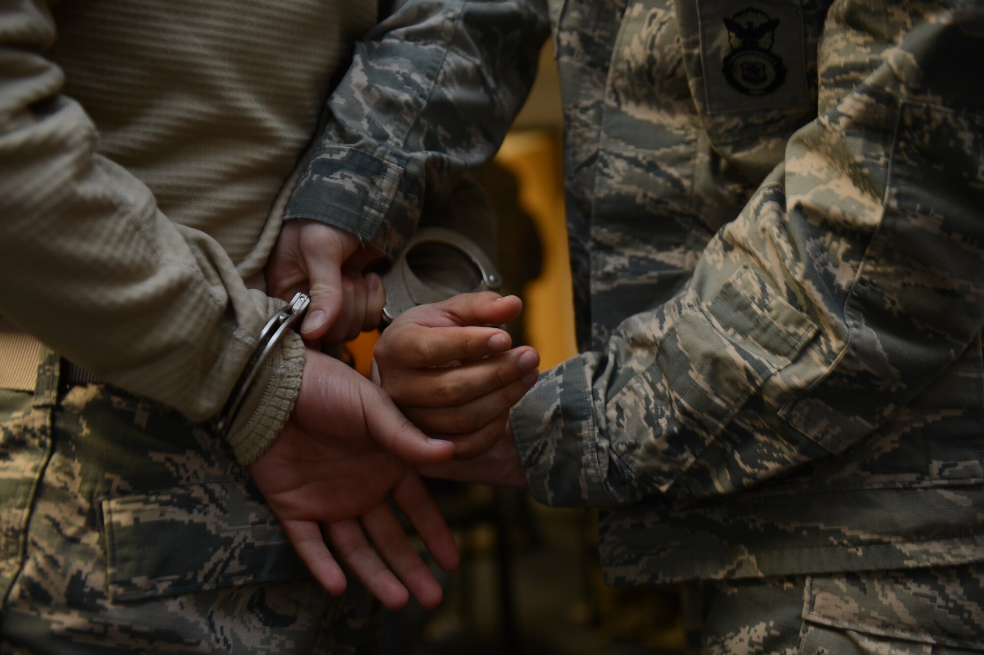 SPANGDAHLEM AIR BASE, Germany – U.S. Air Force Senior Airman Andrew Lehman, 52nd Security Forces Squadron security forces member from San Angelo, Texas, handcuffs U.S. Air Force Airman 1st Class Anthony Santiago, 52nd SFS security forces member from New Port Richey, Fla., during a training exercise April 2, 2013. Security forces members train continually to keep their apprehension abilities proficient in case of real-world situations. (U.S. Air Force photo by Airman 1st Class Gustavo Castillo/Released)