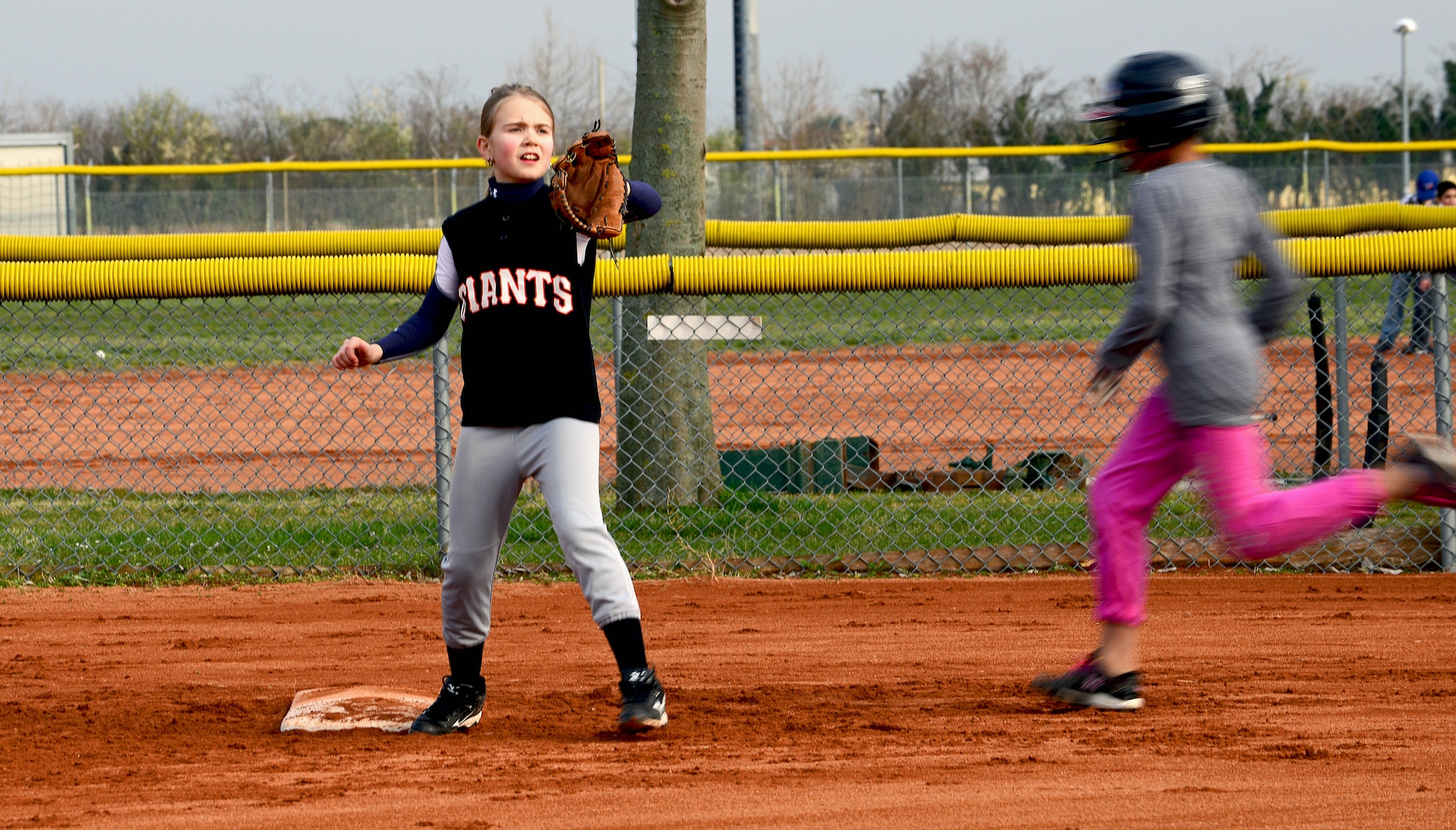 Chloe, daughter of Tech. Sgt. Brian Price, 31st Maintenance Squadron NCO in charge  of the propulsion section, attempts to get an out at first base during practice at Aviano Air Base, Italy, Apr. 1, 2013. Youth 11 and up have a chance to travel around Italy to participate in scheduled games and tournaments. (U.S. Air Force photo/Airman 1st Class Matthew Lotz)