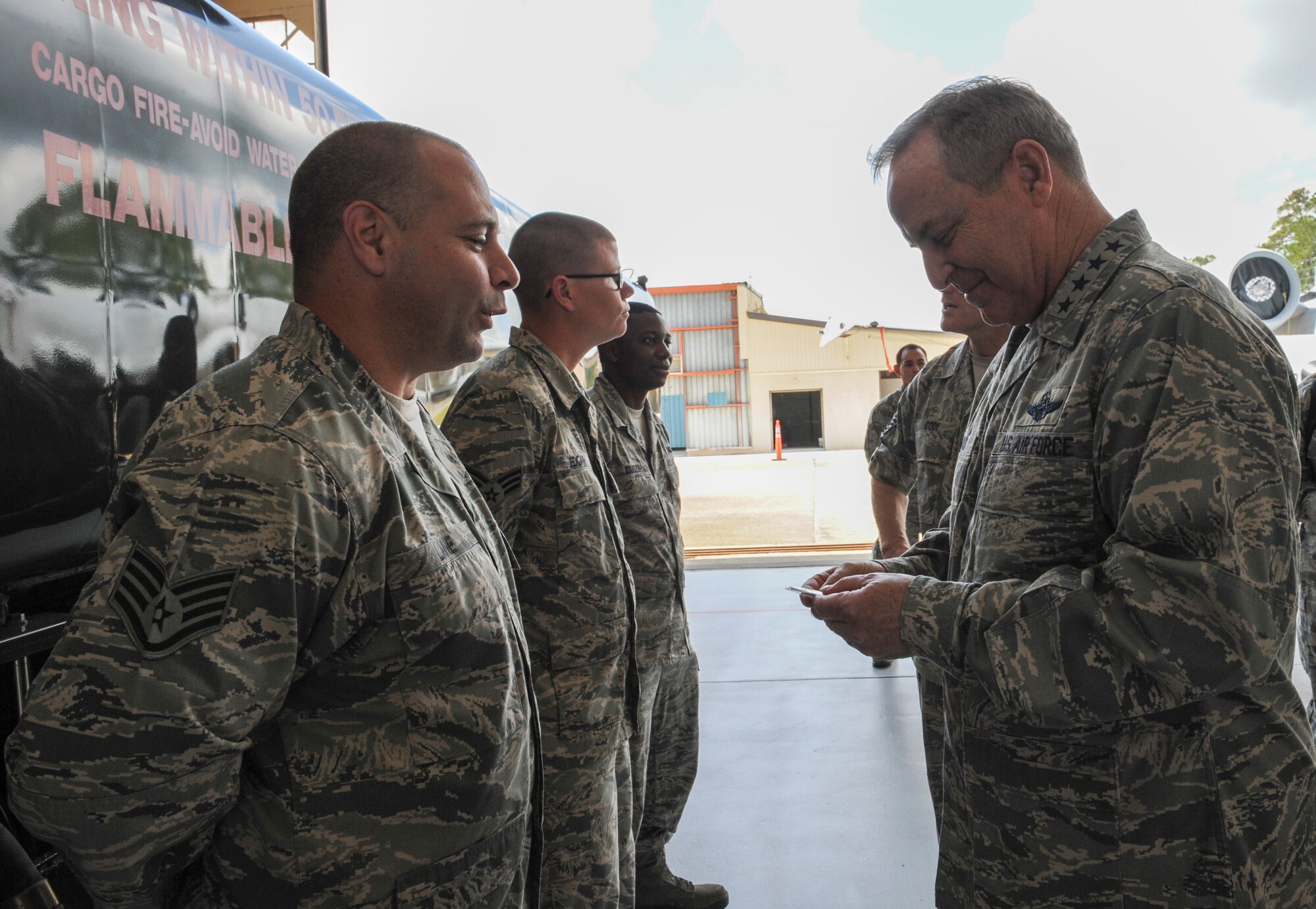 U.S. Air Force Staff Sgt. Jason Lane, 23d Logistics Readiness Squadron fuels management flight, presents a coin to Air Force Chief of Staff Gen. Mark A. Welsh III, April 1, 2013, at Moody Air Force Base, Ga. Welsh and Chief Master Sgt. of the Air Force James Cody came to the base to meet with Airmen, thank them for their service and talk about issues affecting the Air Force. (U.S. Air Force photo by Airman Alexis Grotz)