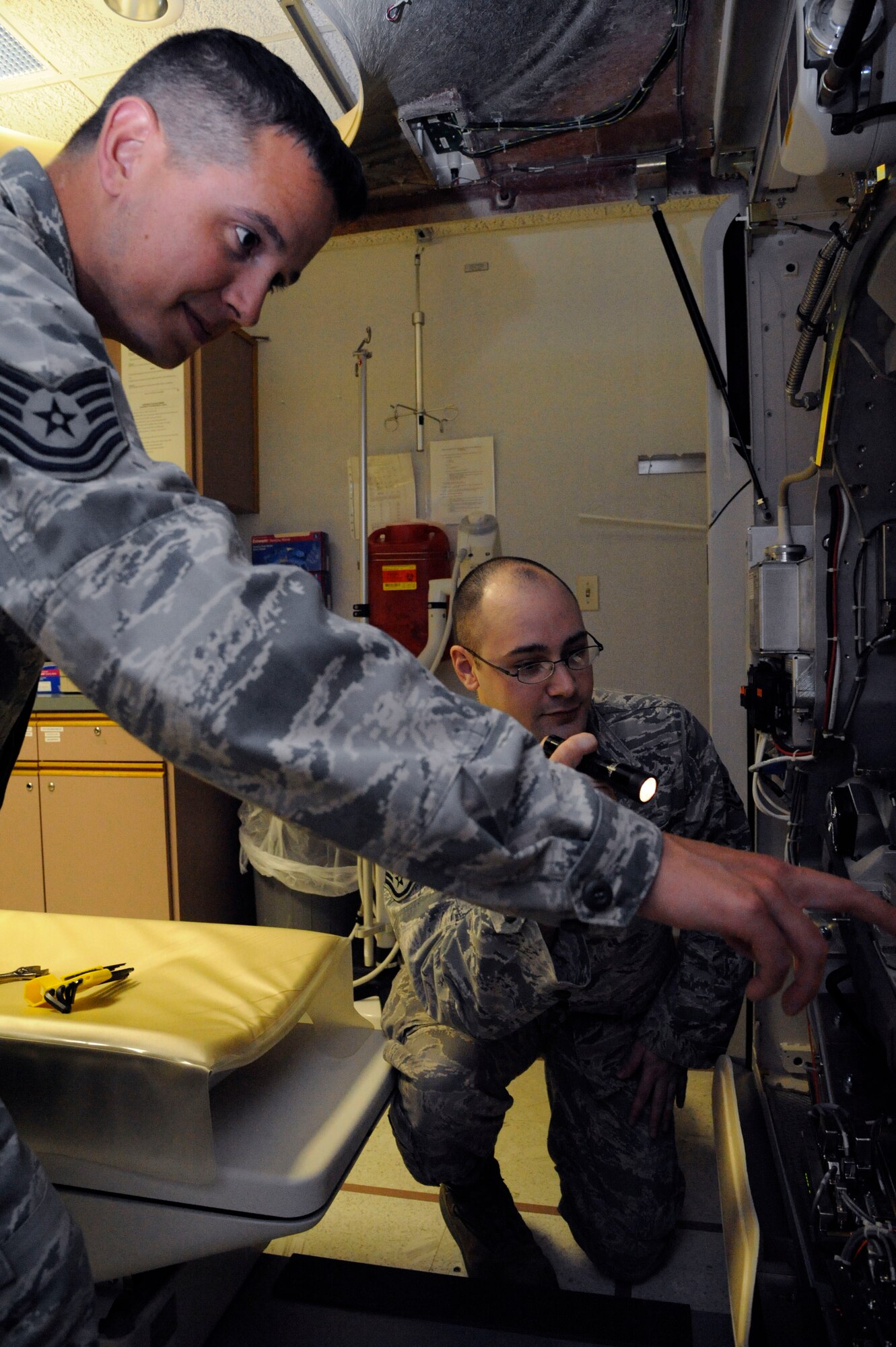 Tech. Sgt. Orlando Ortega, 2nd Medical Group Biomedical Equipment Technician flight chief, and Staff Sgt. Andrew Bouck, 2 MDG BMET NCO in-charge, assess a computed tomography scanner on Barksdale Air Force Base, La., April 2, 2013. BMETs are responsible for the maintenance, upkeep and serviceability of all equipment the 2 MDG uses ranging from pressure cuffs to advanced X-ray machines. (U.S. Air Force photo/Airman 1st Class Andrew Moua)