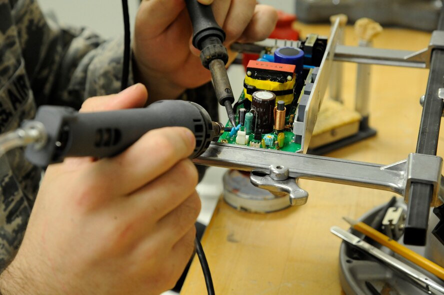 Staff Sgt. Andrew Bouck, 2nd Medical Group Biomedical Equipment Technician NCO in-charge of maintenance, solders a circuit breaker on Barksdale Air Force Base, La., April 2, 2013. The BMET section is in charge of more than 1,300 pieces of medical equipment they must maintain and ensure are serviceable. Equipment ranges from simple blood pressure cuffs to advanced X-ray machines. (U.S. Air Force photo/Airman 1st Class Andrew Moua)