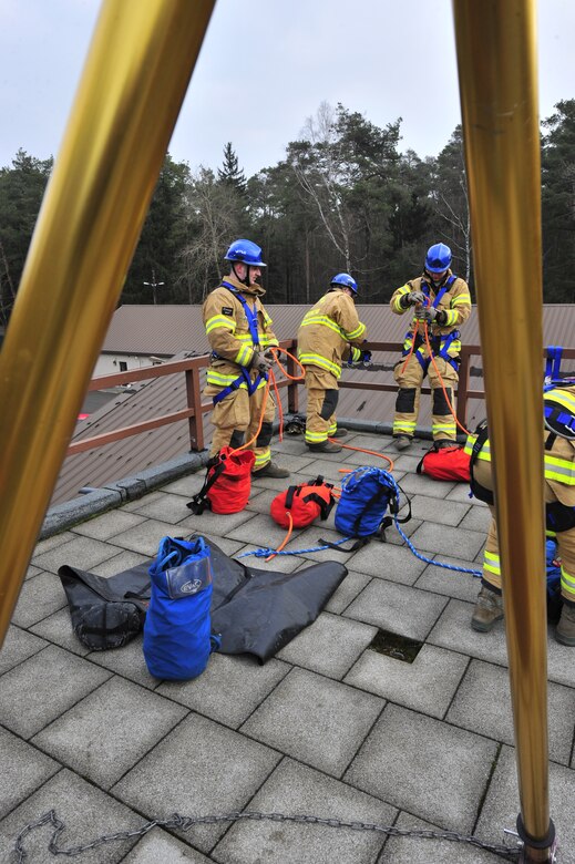 435th Civil Engineer Squadron fire fighters set up a tripod on top of the training facility in order to pull any potential victims out of harms way, March 21, 2013, Ramstein Air Base, Germany. The 435th Construction Training Squadron conducted rescue technician certification training that tested 11 fire fighters in simulated rescue operations. (U.S. Air Force photo/Senior Airman Aaron-Forrest Wainwright)