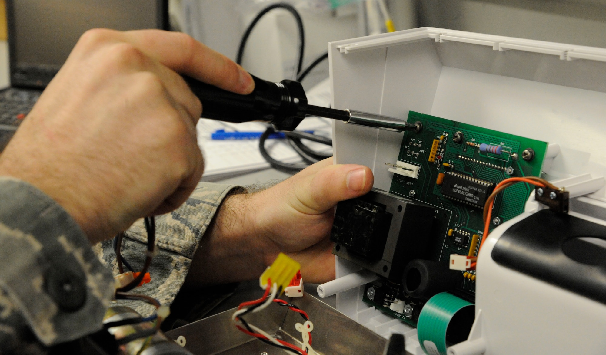 Staff Sgt. Andrew Bouck, 2nd Medical Group Biomedical Equipment Technician NCO in-charge of medical maintenance, unscrews a circuit breaker from an amalgamator on Barksdale Air Force Base, La., April 2, 2013. Amalgamators are used by the 2nd Dental Squadron to mix the composites used to create tooth fillings. (U.S. Air Force photo/Airman 1st Class Andrew Moua)