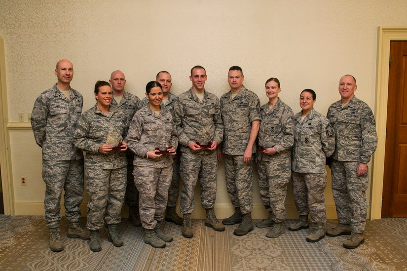 Col. Justin Davey, 628th Mission Support Group commander (left), and Chief Master Sgt. Al Hannon, 628th Air Base Wing command chief (right), recognize March's Diamond Sharp winners April 2, 2013, at the Charleston Club at Joint Base Charleston  -  Air Base, S.C. The Diamond Sharp recipients are (from left) Staff Sgt. Francine Palmer, 628th Force Support Squadron career development supervisor, Senior Airman Sheila Sanchez-Tosado, 628th Communications Squadron unit deployment manager, Airman 1st Class Tony Chase, 628th Logistics Readiness Squadron specialized vehicle maintenance technician, and Senior Airman Jessica Ormston, 628th Security Forces Squadron vehicle control noncommissioned officer-in-charge. Pictured with the Diamond Sharp winners are Master Sgt. Tony Crerar, 628th FSS first sergeant, Master Sgt. David Turnage, 628th CS first sergeant, Senior Master Sgt. Jack Fox, 628th LRS first sergeant, and Senior Master Sgt. Amaria Diaz, 628th SFS first sergeant. Diamond Sharp awardees are Airmen chosen by their first sergeants for their excellent performance. (U.S. Air Force photo/ Senior Airman George Goslin)