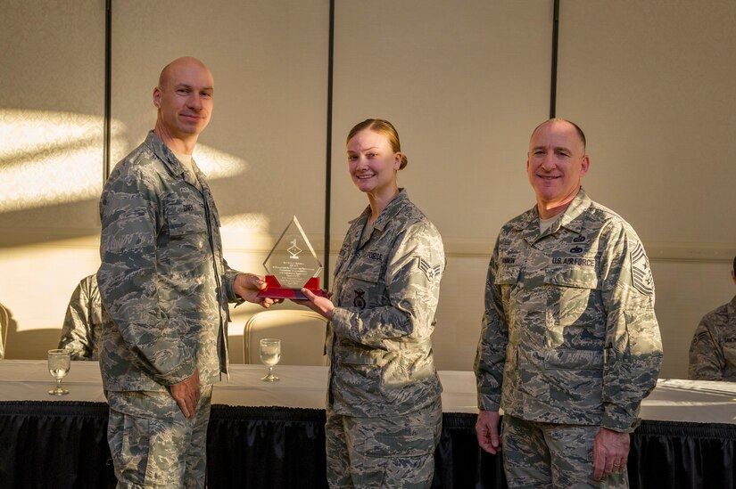 Col. Justin Davey, 628th Mission Support Group commander, and Chief Master Sgt. Al Hannon, 628th Air Base Wing command chief, present a Diamond Sharp award to Senior Airman Jessica Ormston, 628th Security Forces Squadron vehicle control noncommissioned officer-in-charge, during a ceremony April 2, 2013, at the Charleston Club at Joint Base Charleston - Air Base, S.C. Diamond Sharp awardees are Airmen chosen by their first sergeants for their excellent performance. (U.S. Air Force photo/ Senior Airman George Goslin)