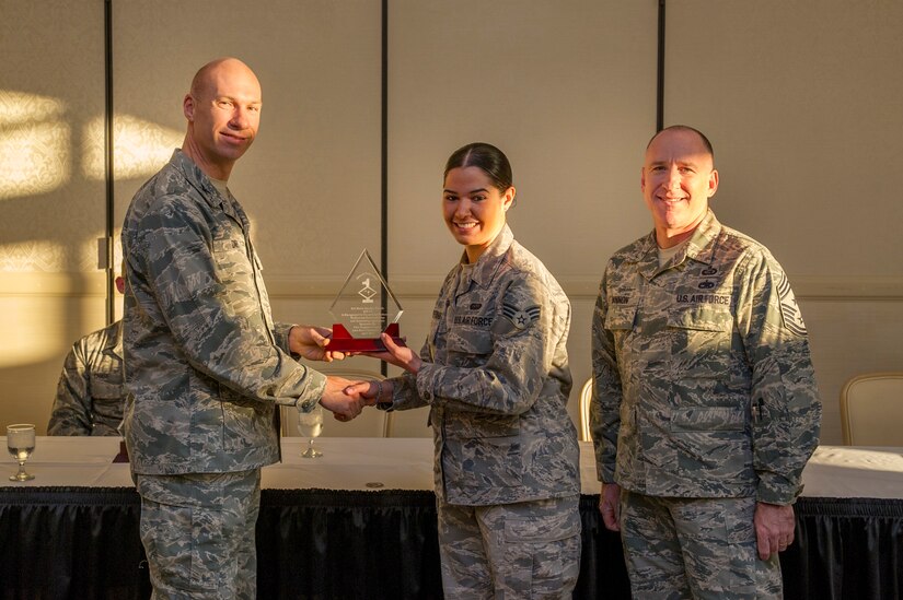 Col. Justin Davey, 628th Mission Support Group commander, and Chief Master Sgt. Al Hannon, 628th Air Base Wing command chief, present a Diamond Sharp award to Senior Airman Sheila Sanchez-Tosado, 628th Communications Squadron unit deployment manager, during a ceremony April 2, 2013, at the Charleston Club at Joint Base Charleston - Air Base, S.C. Diamond Sharp awardees are Airmen chosen by their first sergeants for their excellent performance. (U.S. Air Force photo/ Senior Airman George Goslin)