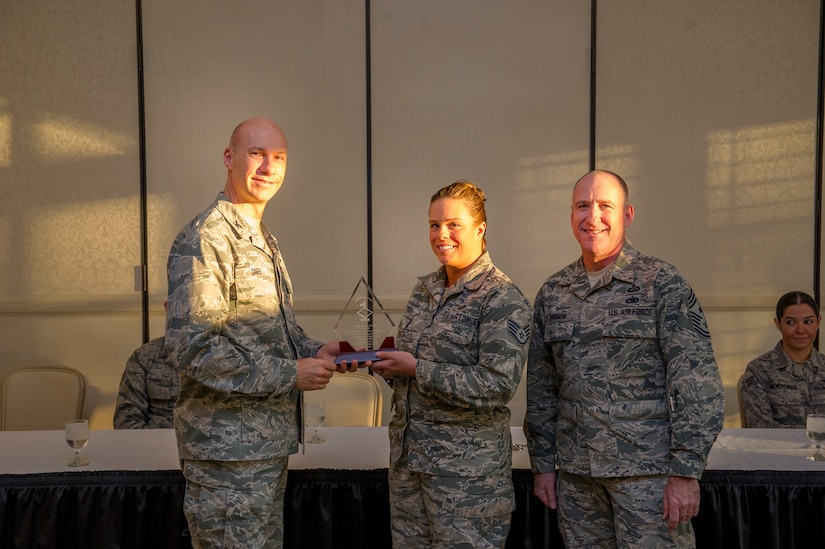 Col. Justin Davey, 628th Mission Support Group commander, and Chief Master Sgt. Al Hannon, 628th Air Base Wing command chief, present a Diamond Sharp award to Staff Sgt. Francine Palmer, 628th Force Support Squadron career development supervisor, during a ceremony April 2, 2013, at the Charleston Club at Joint Base Charleston - Air Base, S.C. Diamond Sharp awardees are Airmen chosen by their first sergeants for their excellent performance. (U.S. Air Force photo/ Senior Airman George Goslin)
