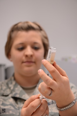 SPANGDAHLEM AIR BASE, Germany – U.S. Air Force Staff Sgt. Sarah Ellis, 52nd Medical Operations Squadron NCO in charge of Allergy and Immunizations from Mount Hood, Ore., fills a syringe with a vaccine to administer to a patient April 2, 2013. Vaccines provide Airmen with the ability to fight off infectious diseases. The clinic administers more than 1,500 immunizations monthly to 52nd Fighter Wing members and their families. (U.S. Air Force photo by Airmen 1st Class Kyle Gese/Released)