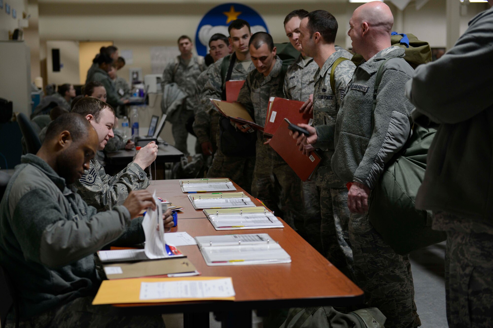 Airmen process through a line checking their professional records for deployment at the Joint Mobility Center during exercise Polar Force 13-3 on Joint Base Elmendorf-Richardson, April 2. The exercise is designed to validate the 673d Air Base Wing’s ability to integrate, mobilize, and prepare assigned personnel, aircraft and equipment for their wartime mission and to employ forces and weapons systems to perform tasked missions. (U.S. Air Force photo/Airman 1st Class Tammie Ramsouer)