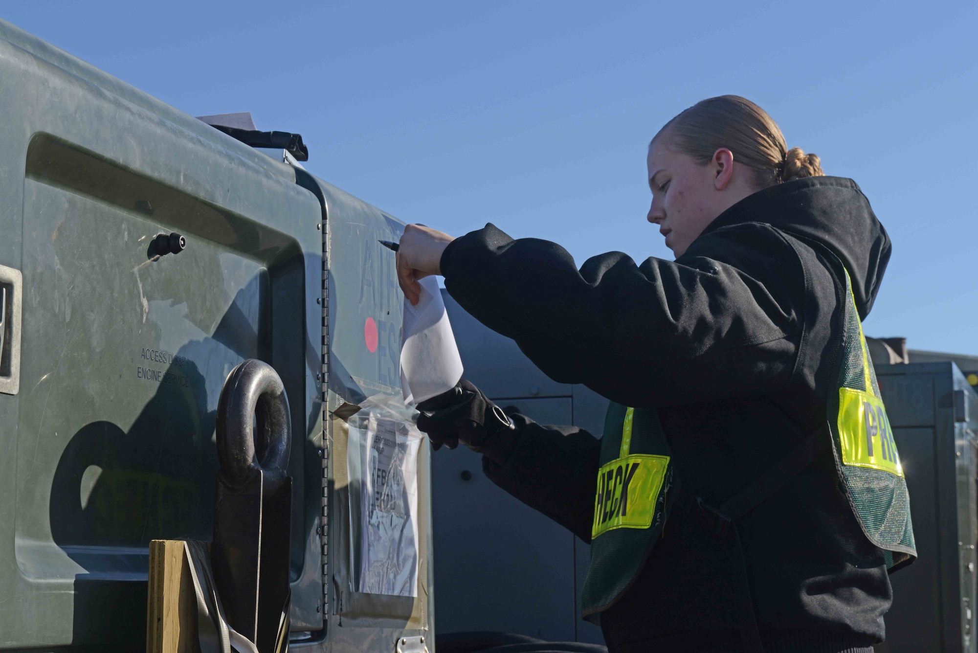 Airman 1st Class Nina Thielman, a 773d Logistics Readiness Squadron heavy equipment vehicle mechanic, fills out a checklist for cargo inspection as part of the Polar Force 13-3 Exercise April 2. The mission of the 773d LRS during the exercise is to transport cargo to and from deployed locations. The exercise is designed to test military readiness in the event of a natural disaster or military conflict.  (U.S. Air Force photo/Airman Ty-Rico Lea)