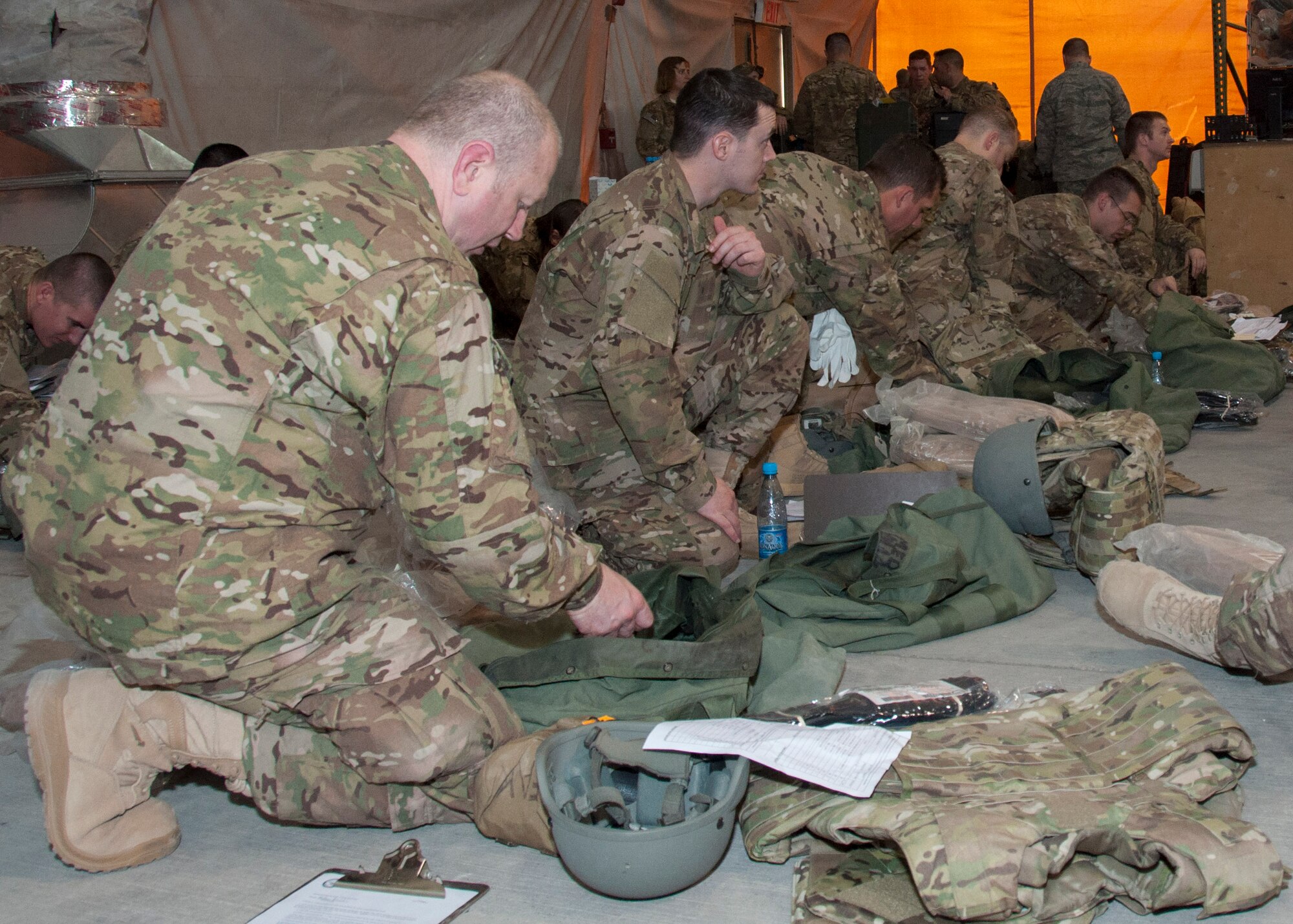 Transient Airmen conduct an inventory of their issued C-bags in the Expeditionary Theater Distribution Center March 29, 2013, at Transit Center at Manas, Kyrgyzstan. Approximately 200 to 500 Airmen process through ETDC each week for equipment issue. (U.S. Air Force photo/Tech. Sgt. Rachel Martinez)