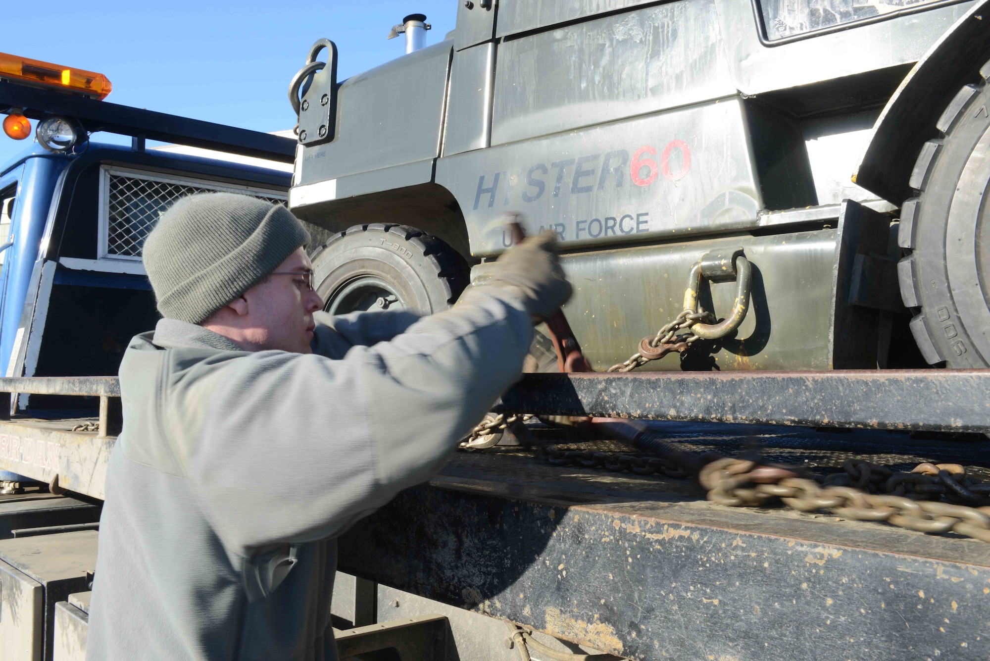 Airman 1st Class Andrew Schoon, a 773d Logistics Readiness Squadron vehicle operations journeyman, prepares to dismount an ammunition loader from a truck bed at the Joint Mobility Center as part of the Polar Force 13-3 Exercise April. 2. The mission of the 773d LRS during the exercise is to transport cargo to and from deployed locations. The exercise is designed to test military readiness in the event of a natural disaster or military conflict. (U.S. Air Force photo/Airman Ty-Rico Lea)