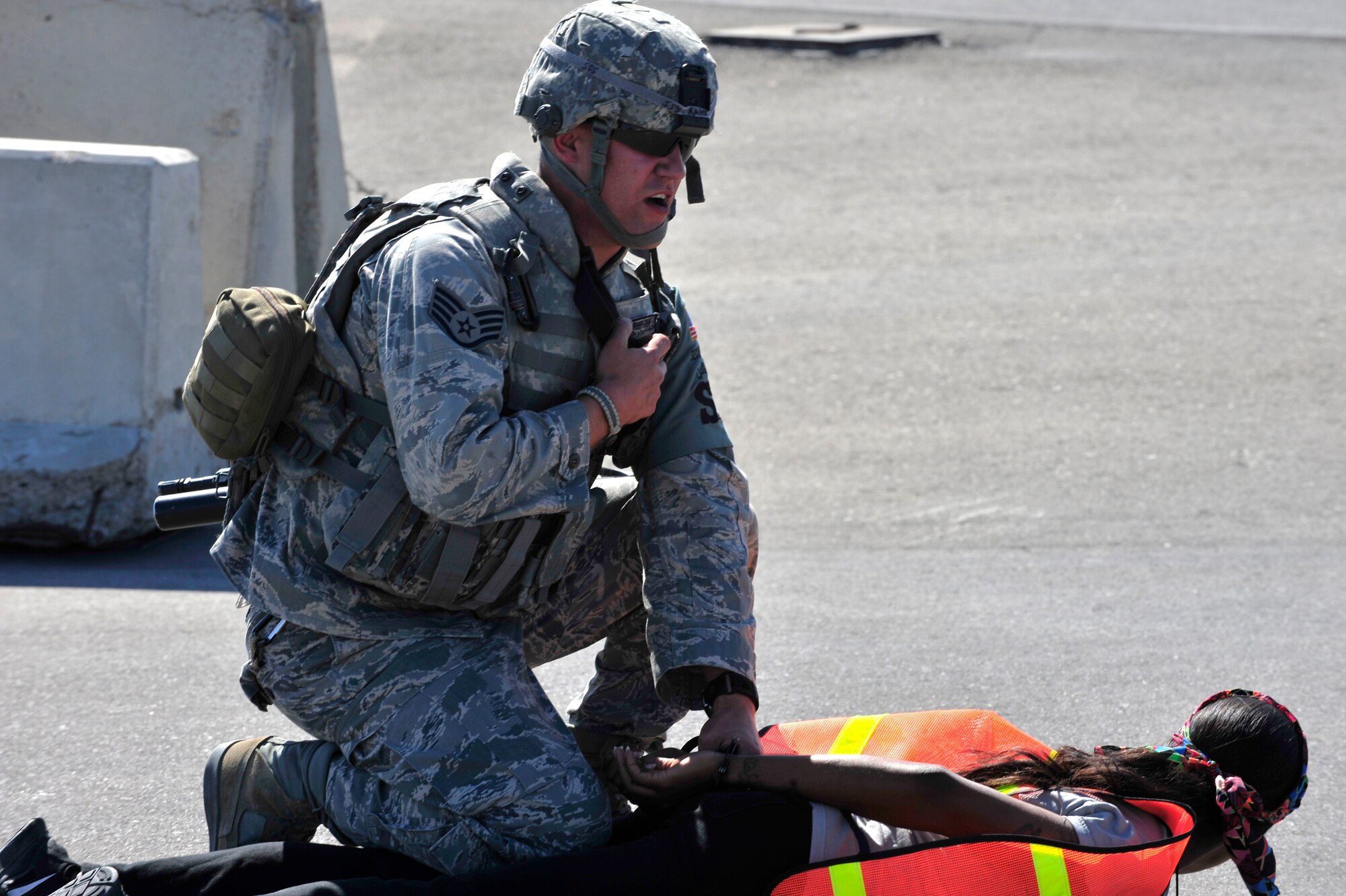 U.S. Air Force Staff Sgt. Daniel Kaltenegger, 380th Expeditionary Security Forces Squadron patrolman, apprehends an intruder played by Staff Sgt. Tiffany Cooke, 380 SFS training member, during a base defense exercise at an undisclosed location in Southwest Asia Mar. 29, 2013. The exercise objective was to test the security forces reaction-time in the event that intruders threatened Air Force assets. Kaltenegger is deployed from Pennsylvania Air National Guard. (U.S. Air Force photo by Tech. Sgt. Christina M. Styer/Released)  