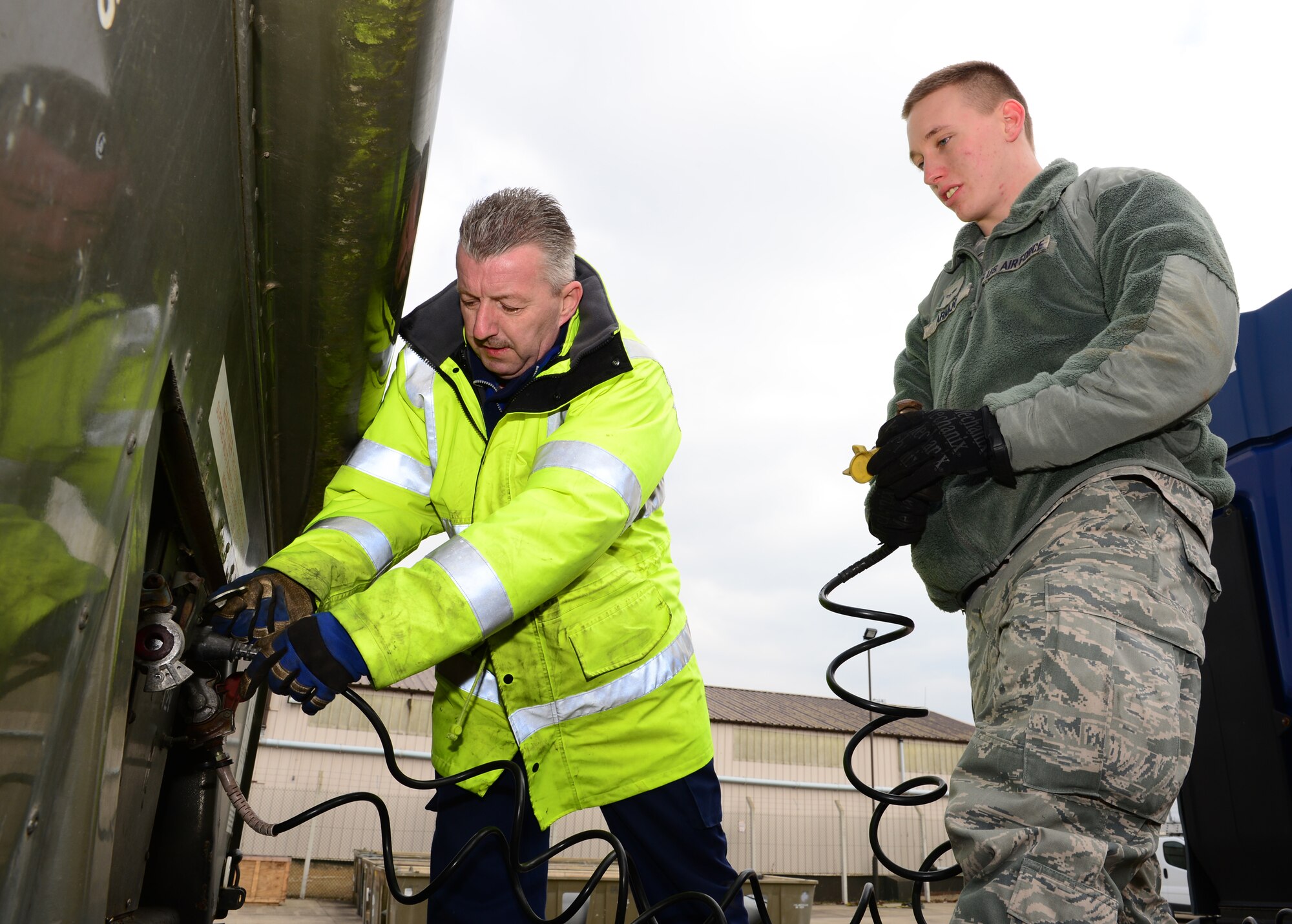 ROYAL AIR FORCE LAKENHEATH, England – David Cummings, 48th Logistic Readiness Squadron training and validations certifier, teaches Airman 1st Class Dante Armijo, 48th LRS vehicle operator apprentice, on detaching the tractor from the trailer, March 27, 2013. Cummings won the 2012 Air Force Transportation Civilian Technician of the Year Award. (U.S. Air Force photo by Staff Sgt. Stephanie Mancha) 