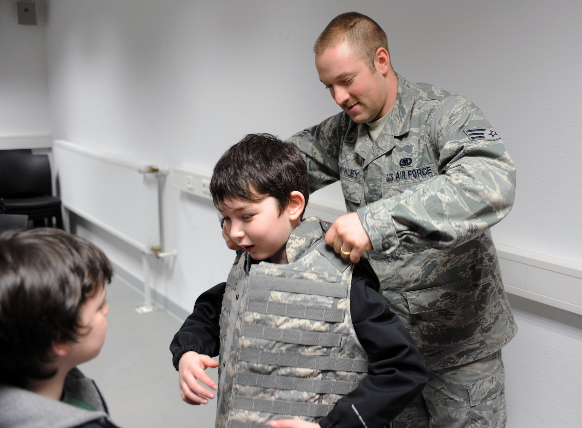 SPANGDAHLEM AIR BASE, Germany — Aiden Brittian, son of Elmira and U.S. Air Force Tech. Sgt. James Brittan, 52nd Component Maintenance Squadron from Nacogdoches, Texas, tries on body armor during a Children’s Deployment Day event at the 52nd Logistics Readiness Squadron, Installation Deployment Readiness Cell March 29, 2013, at Spangdahlem Air Base. More than 600 children from the Spangdahlem and Bitburg elementary schools attended the three-day event to learn what their parents go through when preparing for deployments.  (U.S. Air Force photo by Tech. Sgt. Kenya Shiloh/Released)
