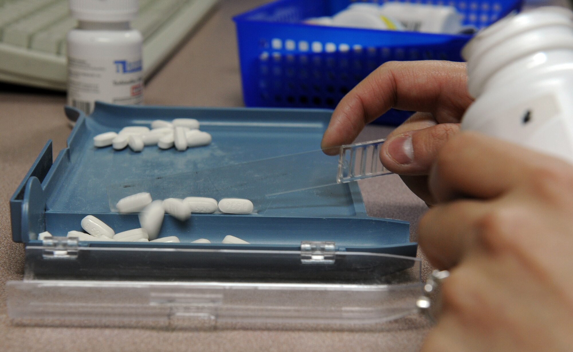 U.S. Air Force Airman 1st Class Dominique Abrams, 35th Medical Support Squadron pharmacy technician, counts prescription pills at Misawa Air Base, Japan, April 2, 2013. When a patient’s medication is not available for order from other manufacturers, pharmacists use an authorized compound recipe binder to make the medication specific to the patients’ needs. (U.S. Air Force photo by Airman 1st Class Kia Atkins)