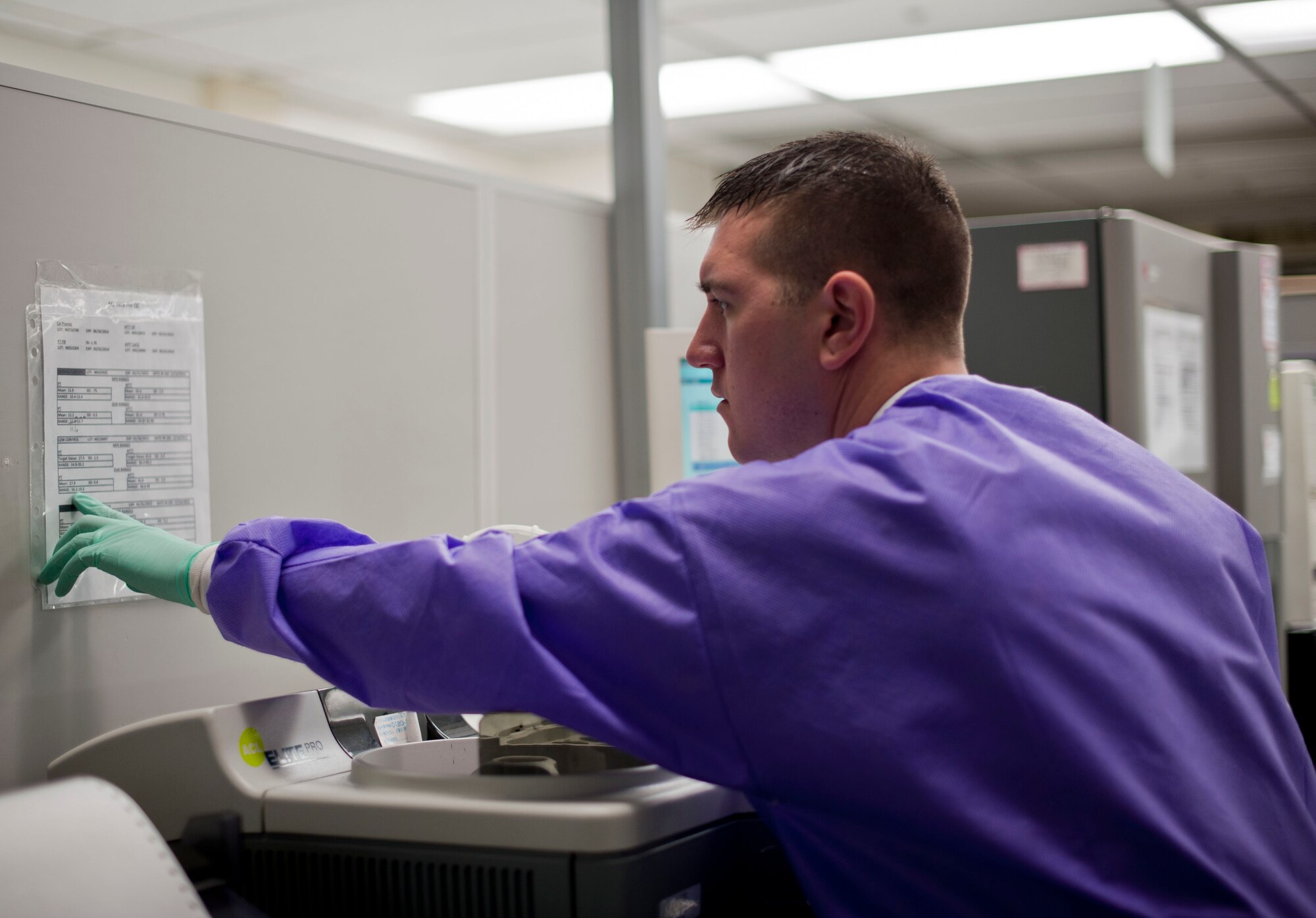 YOKOTA AIR BASE, Japan -- Senior Airman Jon Claus, 374th Medical Support Squadron medical laboratory technician, references a chart at Yokota Air Base, Japan, April 1, 2013. The laboratory offers many services including phlebotomy, urine analysis, chemistry and microbiology. (U.S. Air Force photo by Airman 1st Class Meagan Schutter)
